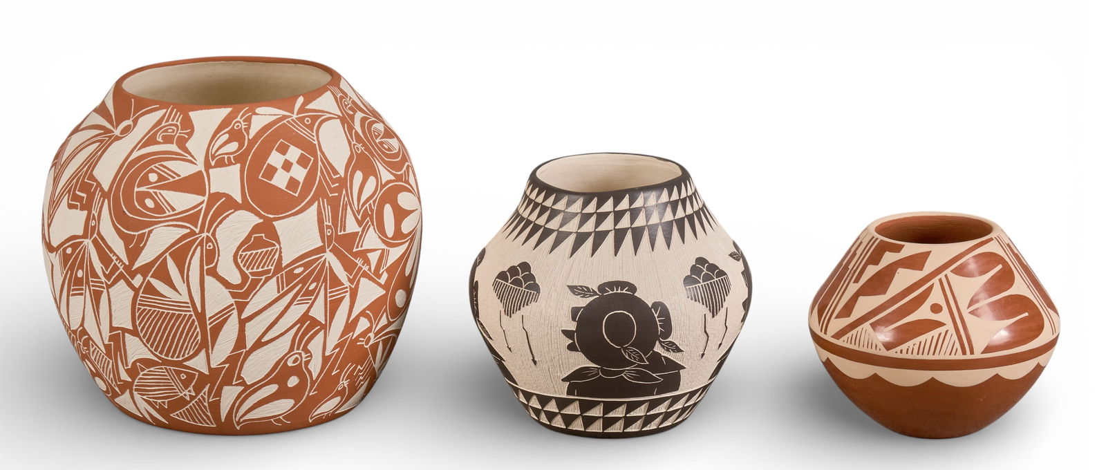 (3) Acoma Pueblo Carved Pottery Vessels: Collection of three Acoma Pueblo pottery vessels, includes pieces by A. Aragon, C.G Loretto Jemez, and Lucario Lagunaheight 6 in. x diameter 7 in.Provenance: Property from a San