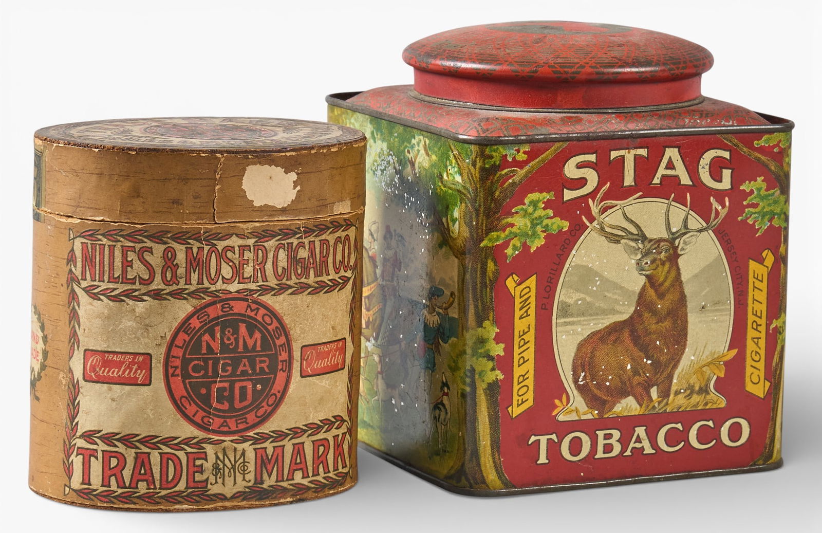 Stag Tobacco & Niles Moser Cigar Tin: Two vintage tobacco and cigar tins, with one Stag Tobacco tin with a stag graphic and a Niles & Moser Cigar Co. tinheight 6 in. x width 5 in. x depth 5 in. Provenance: Property from the