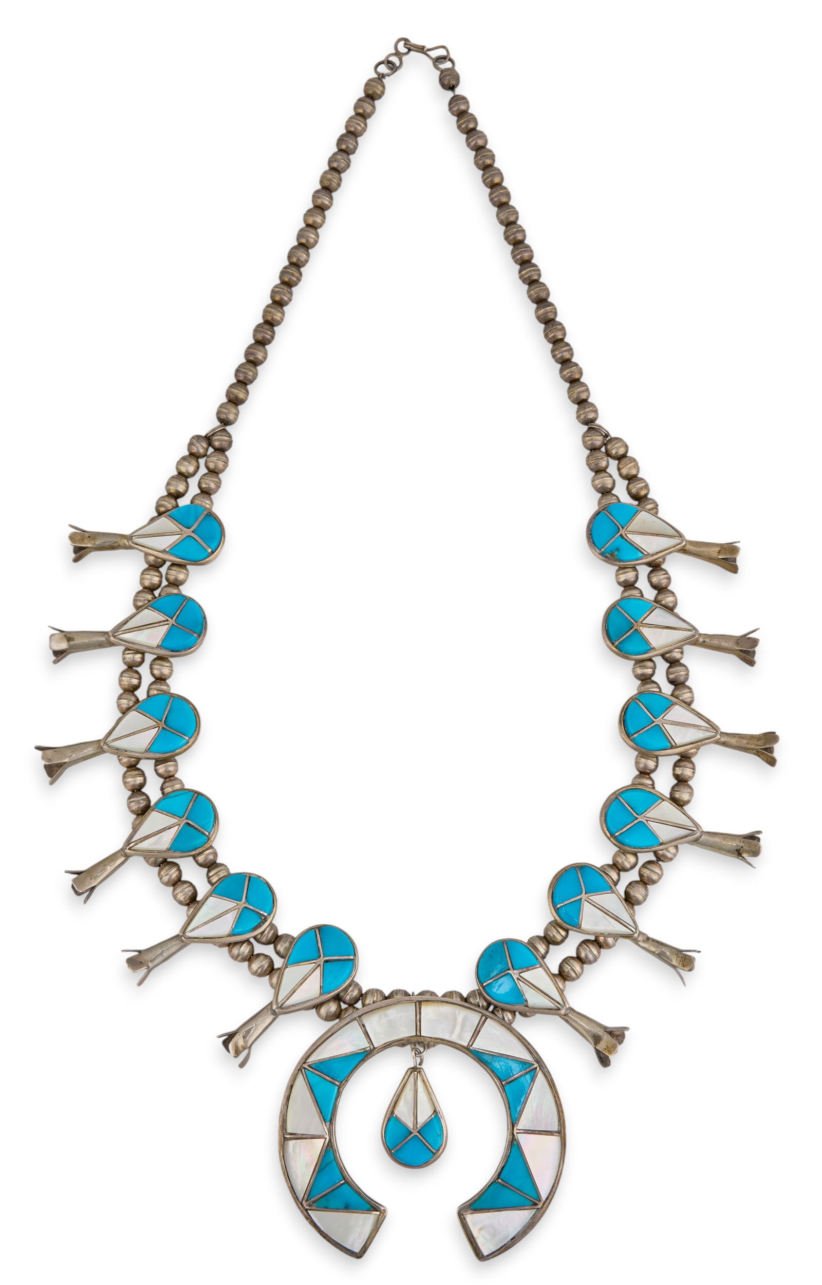 Sterling Silver Turquoise & Mother of Pearl Squash Blossom: Native American sterling silver squash blossom necklace, set with turquoise and mother of pearl inlay in geometric design, and hook and eye closureLength: 24 in. Total weight: 4.295