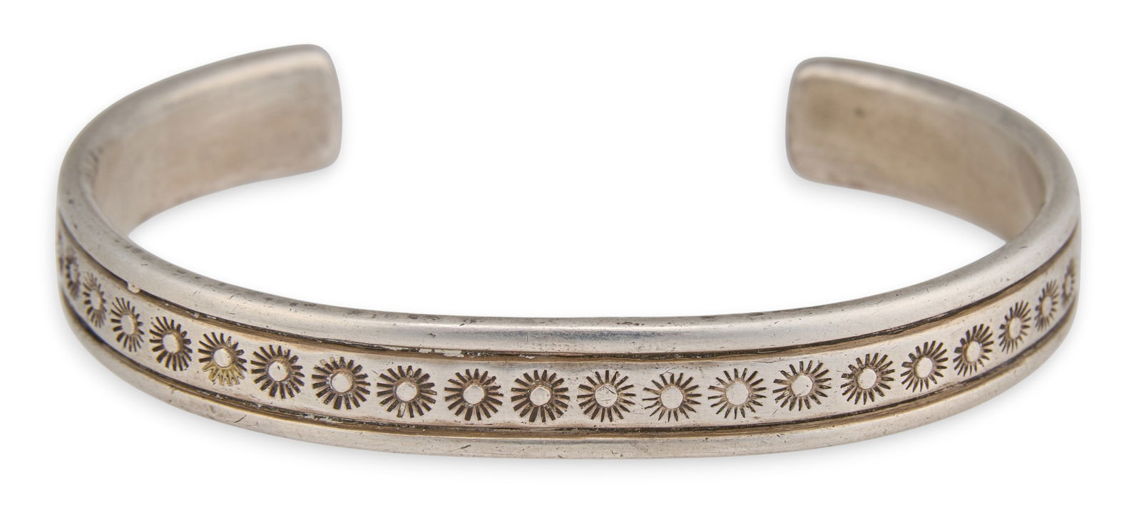 Navajo Sterling Silver Cuff: Navajo sterling silver cuff bracelet, with stamped design throughout, marked "J. Jim" and "Sterling"Circumference: 7.25 in. Total weight: 1.38 oztProvenance: Property from the
