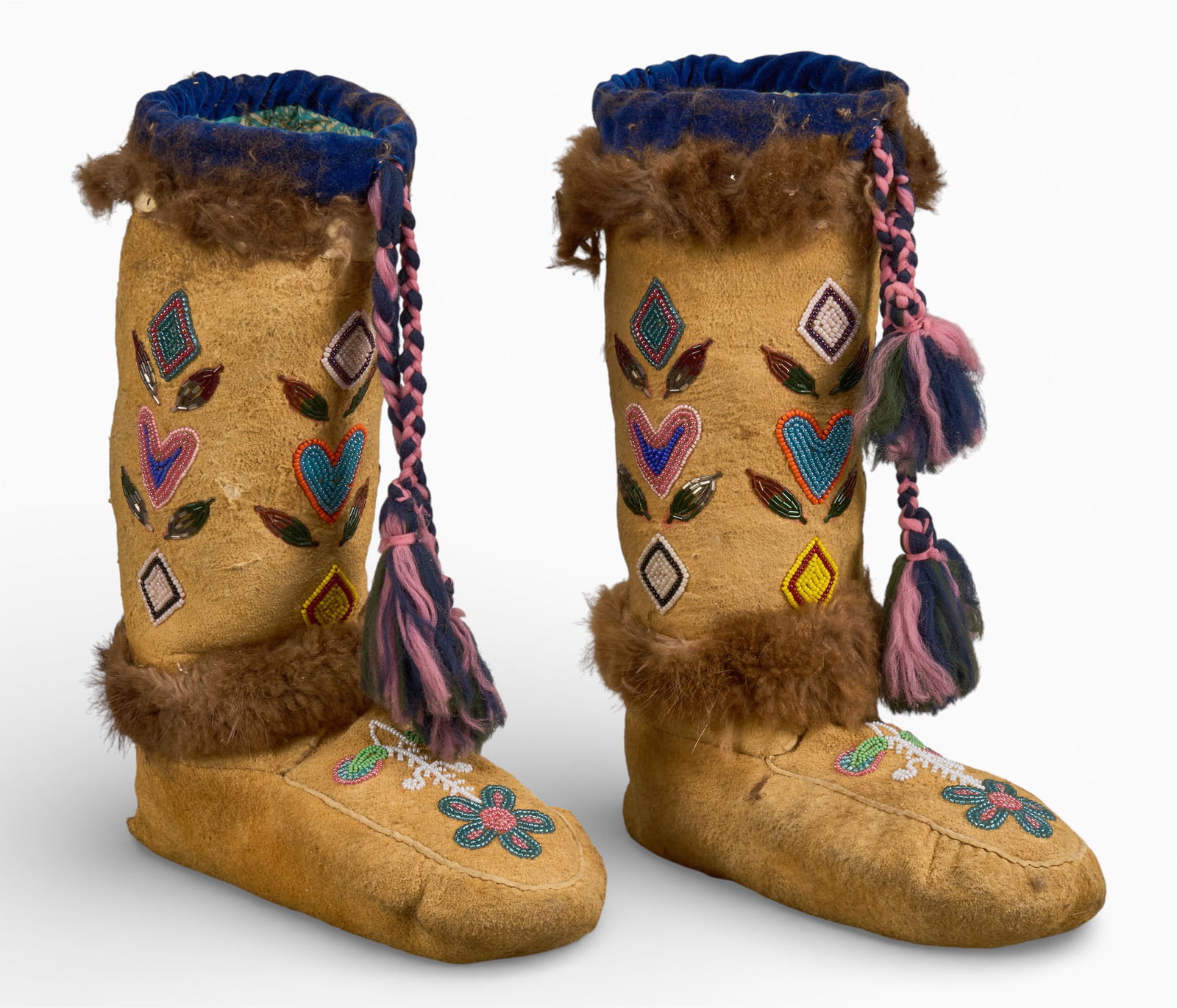 Pair of Beaded Moccasins: Pair of Native American style high-top moccasins of soft tanned hide, with hand-sewn beaded details, with floral and heart motifs height 14.5 in. x width 11 in. x depth 4