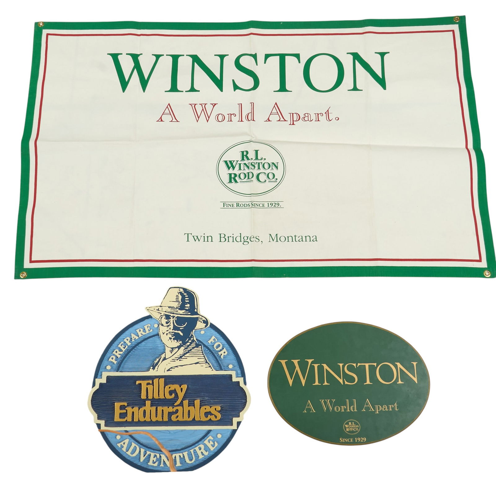 (3) Sporting Goods Advertising Signs: Collection of three advertising signs for sporting goods establishments, includes one large fabric banner, and one oval board sign for R.L. Winston Rod Co. in Twin Bridges, Montana, and one singl