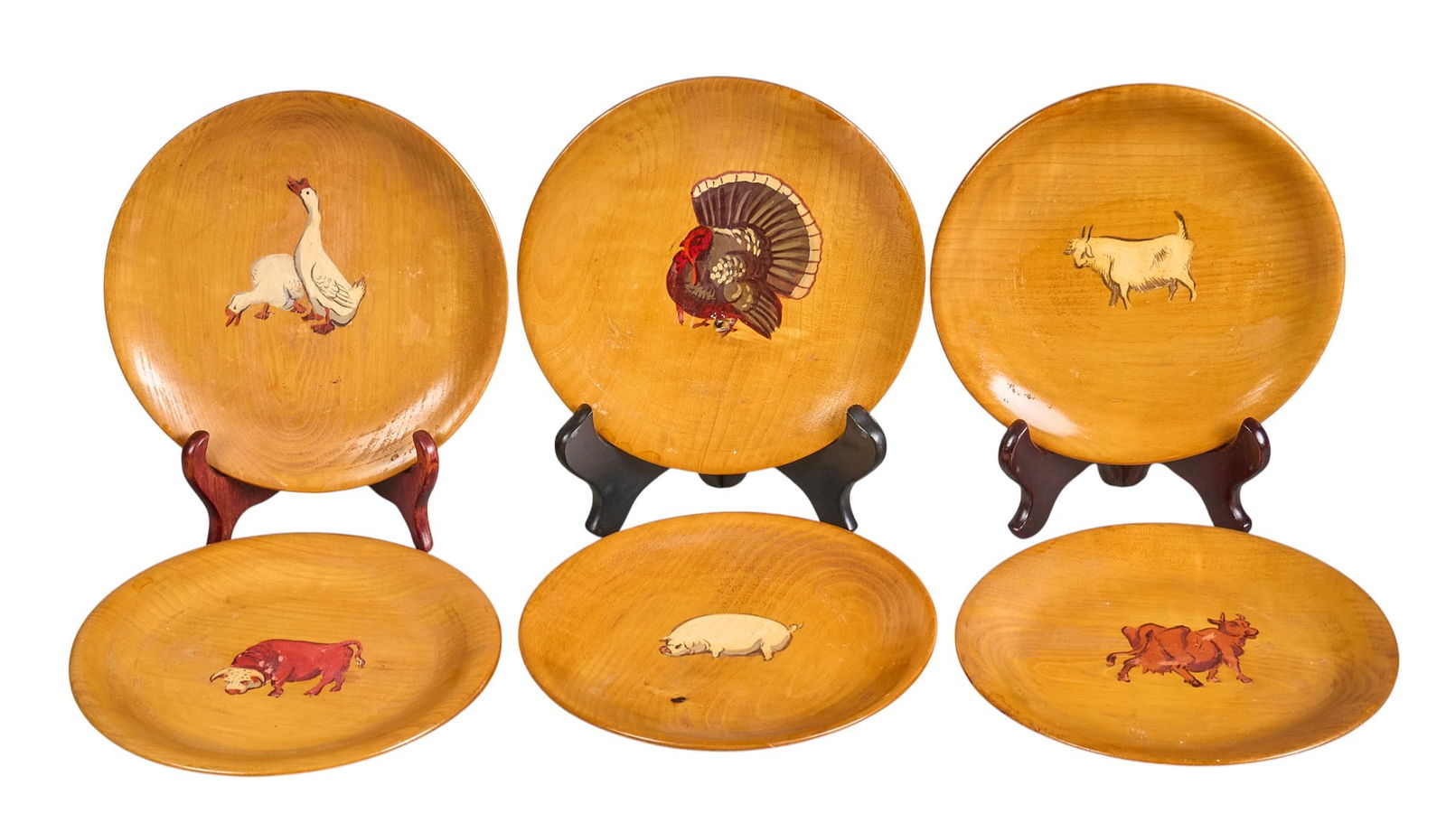 (6) Otis Dozier Painted Plates: Otis Dozier (Texas, 1904-1987), wooden luncheon plates, each painted by Dozier for his wife with individual farm animals (turkey, pig, cow, bull, goat, pair of geese)height 0.75 in. x 8 in.