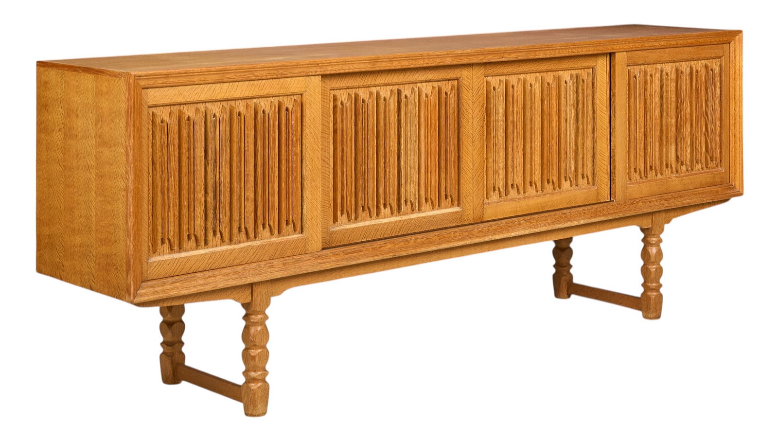 Danish Mid-Century Credenza: Danish mid-century credenza with four sliding doors featuring decorative design opening to shelved interiors, supported on sculpted block legs height 35.5 in. x width 92.5 in. x depth 19 in.