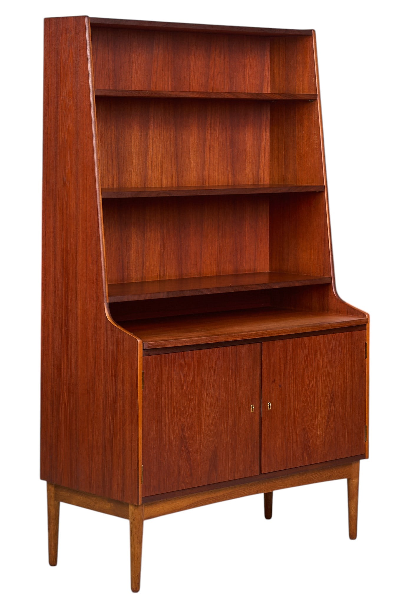 Danish Mid-Century Bookcase: Danish mid-century bookcase with two open shelves, and bottom cabinet with single shelf, supported on pin legsheight 65.5 in. width 39.5 in. x depth 18.5 in.