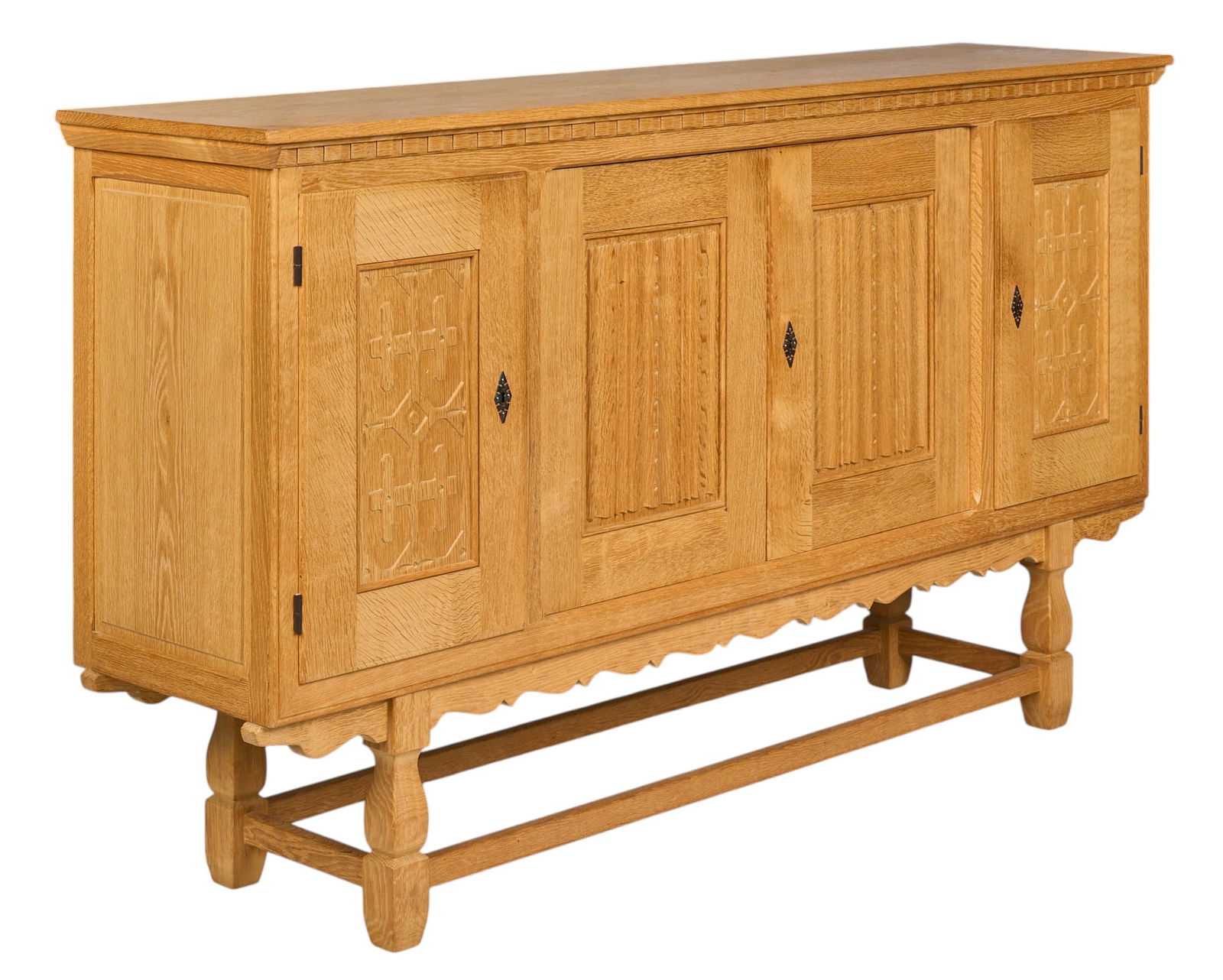Henning Kjaernulf, Mid-Century Credenza: Henning Kjaernulf (Denmark) mid-century oak credenza with four decoratively carved doors opening to interior shelves and flatware trays, supported on sculpted legsheight 45.5 in. x width 81.5 in. x