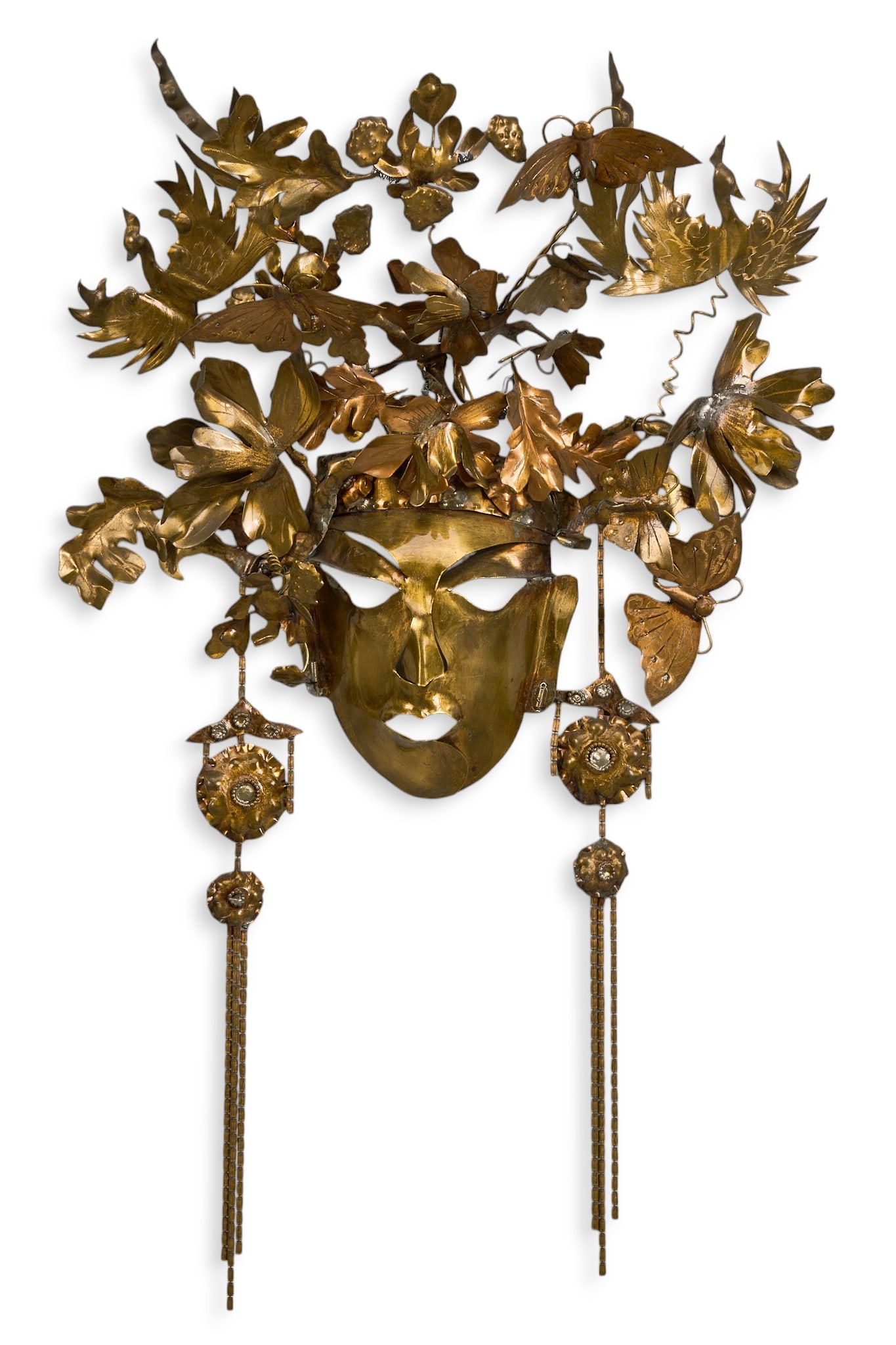 Lee Menichetti, Brass Wall Sculpture: Lee Menichetti (New York, 1931-1997), stylized mask with ornate headdress, brass wall sculpture, Brutalist style, marked with signature inside mask faceheight 21.5 in. x width 13.5 in. x depth