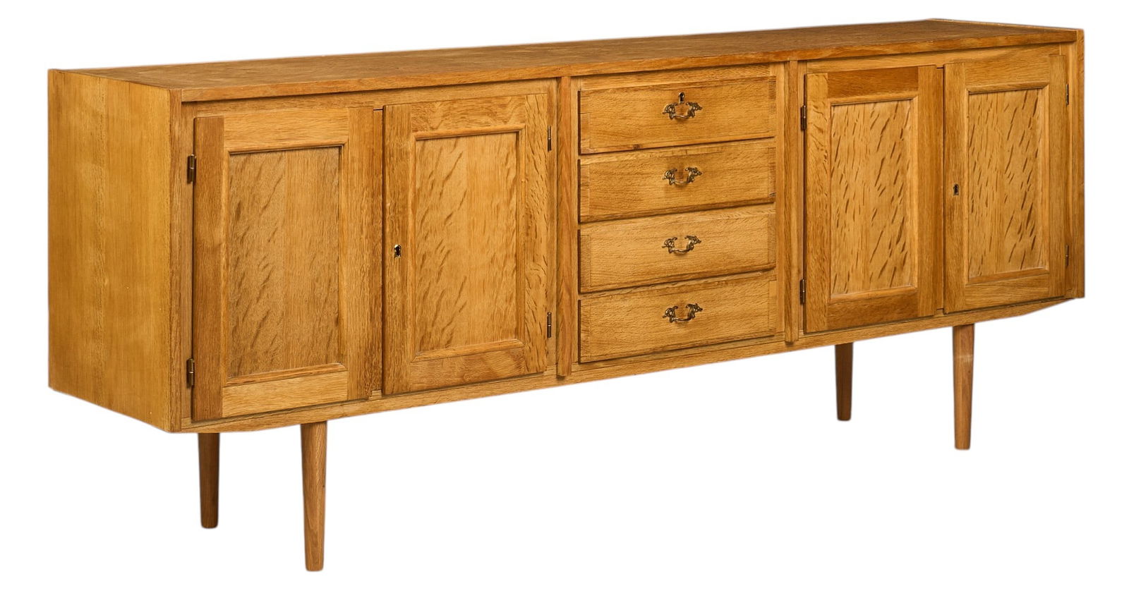 Danish Mid-Century Credenza: Henning Kjaernulf (Denmark) oak mid-century credena with two pairs of paneled doors opening to interior storage, and middle stack of four drawers with brass pulls, supported on pin legs,