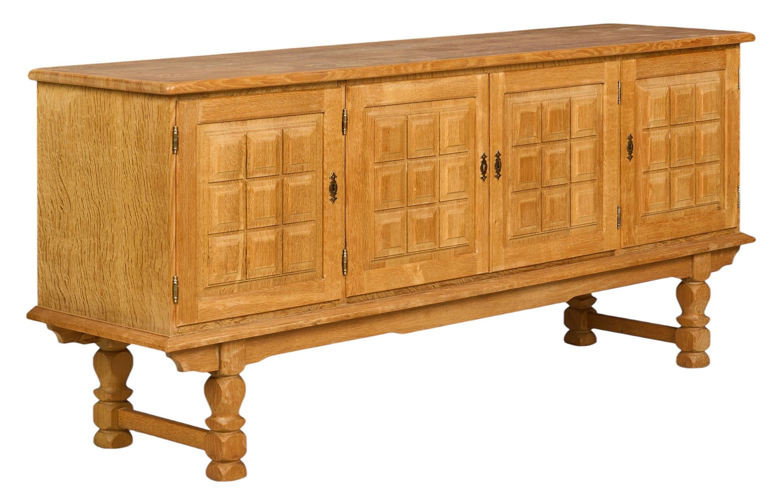 Henning Kjaernulf, Mid-Century Credenza: Henning Kjaernulf (Denmark) mid-century oak credenza with four decoratively carved doors opening to shelved interiors, supported on turned legsheight 33.5 in. x width 75.5 in. x depth 19.5