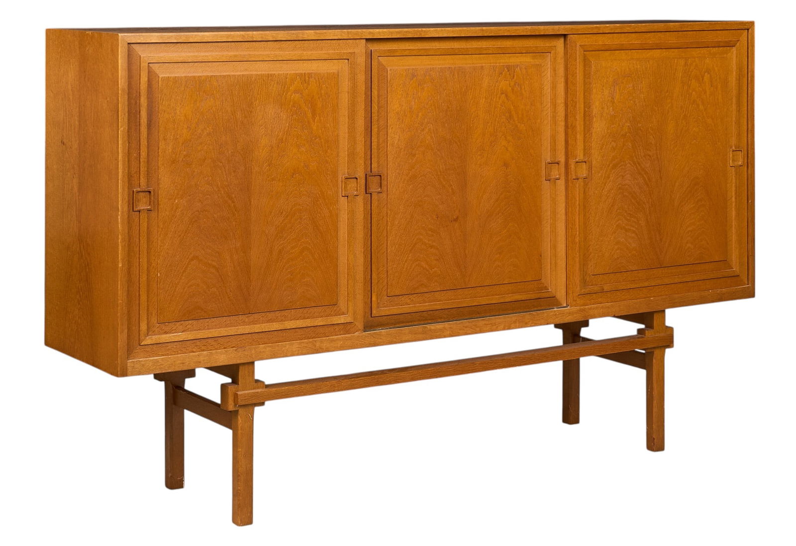 Danish Mid-Century Credenza: Danish mid-century cantilever credenza with four sliding cabinet doors opening to various shelved storage, with mirrored back section with black glass shelf, supported on block legs height 47