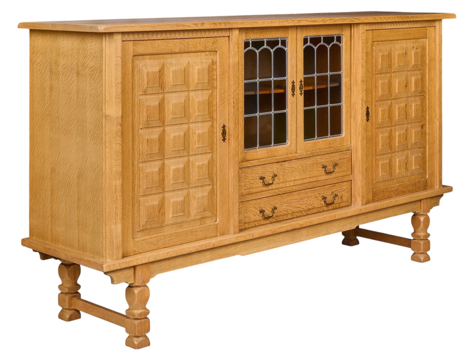 Henning Kjaernulf, Mid-Century Credenza: Henning Kjaenulf (Denmark) mid-century oak credenza with pair of leaded glass-front doors, two cabinet doors, and pair of shelves, supported on sculpted block legsheight 45 in. x width 81 in. x depth