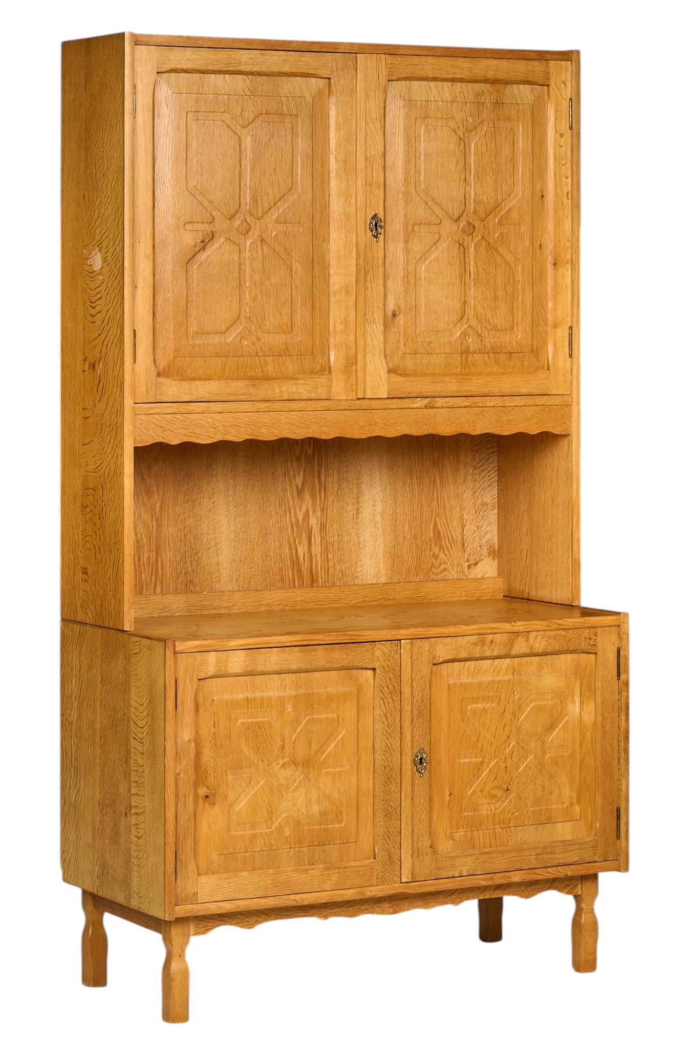 Henning Kjaernulf, Mid-Century Cabinet: Henning Kjaernulf (Denmark) mid-century oak cabinet, top section with a pair of decorative doors, supported on a cabinet with matching doors, raised on sculpted legs height 71 in. x width 39.5
