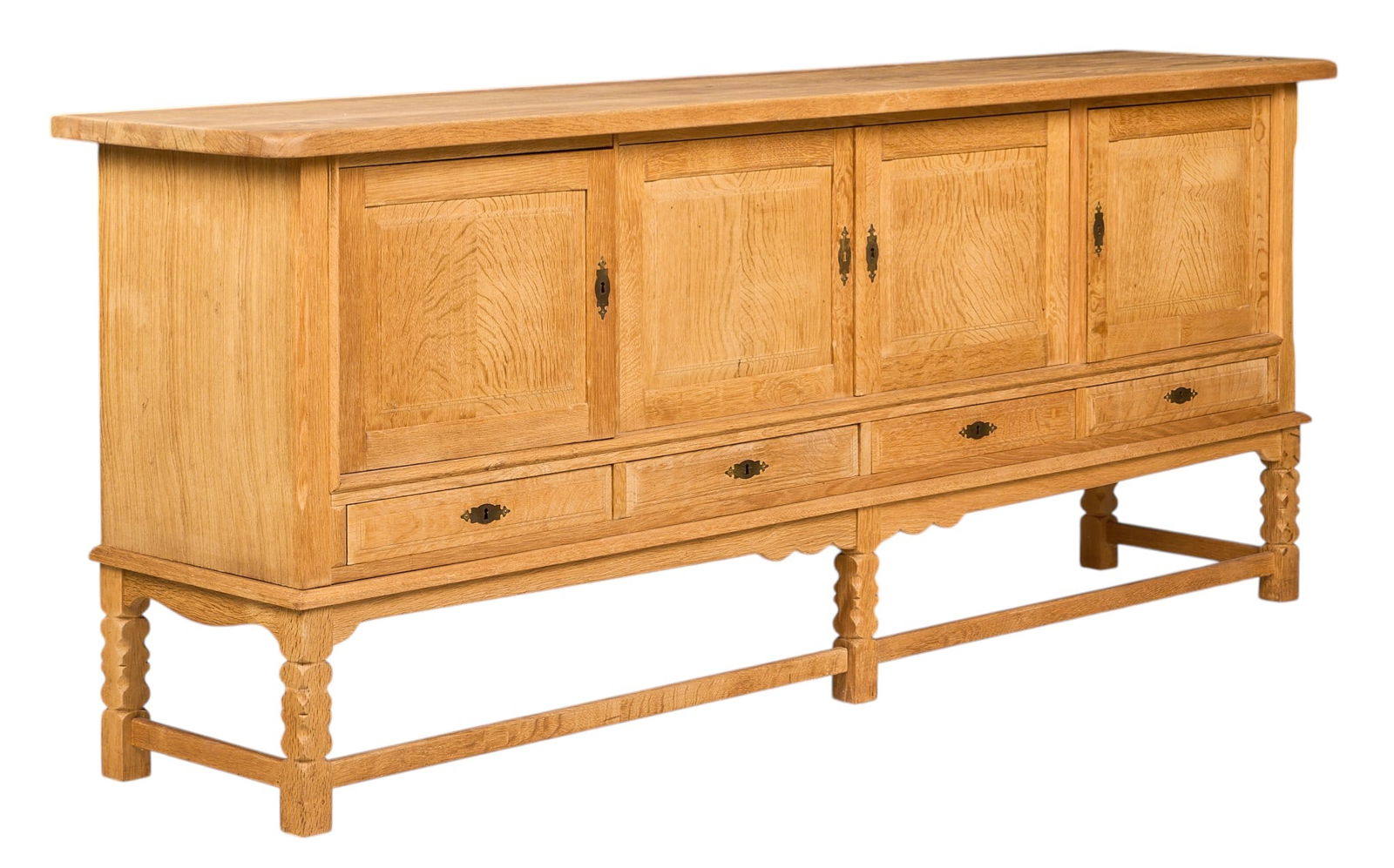 Henning Kjaernulf, Mid-Century Credenza: Henning Kjaernulf (Denmark) mid-century credenza with four doors, four drawers, and interior shelves, supported on sculpted block legs height 36 in. x width 89 in. x depth 19.5 in. 