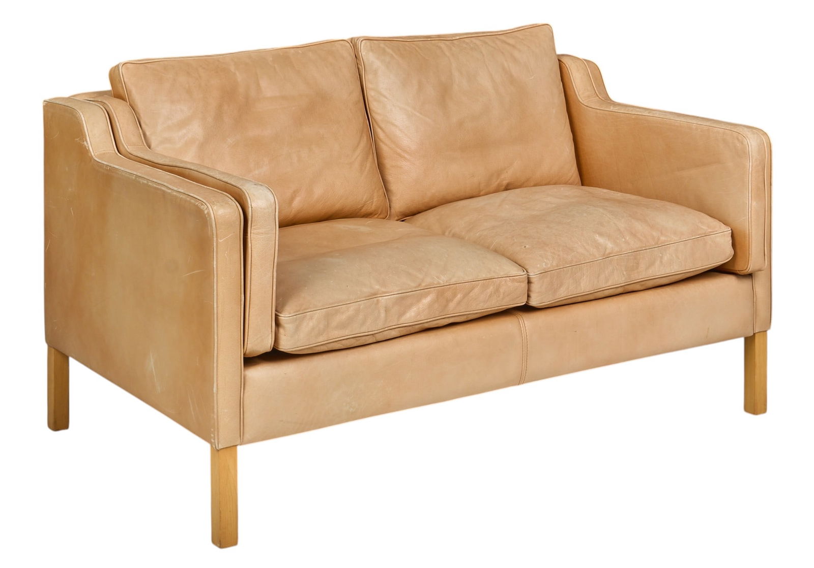 Danish Mid-Century Loveseat: Danish mid-century loveseat with warm cream colored leather upholstery, supported on block legs height 28 in. x width 55 in. x depth 32 in.
