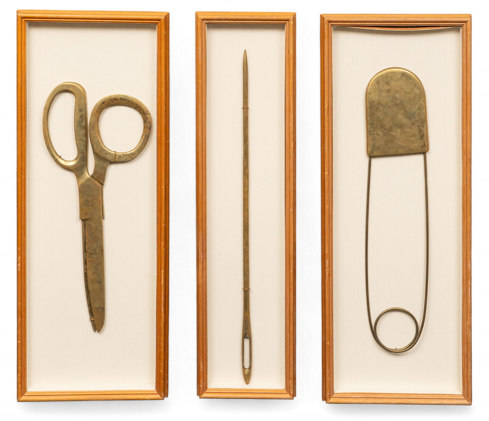 Framed Oversized Scissors, Needle, Safety Pin: Set of framed and oversized sewing tools, includes scissors, a needle, and a safety pin, each mounted within a rectangular frameheight 39 in. x width 15 in. x depth 2 in.Provenance: