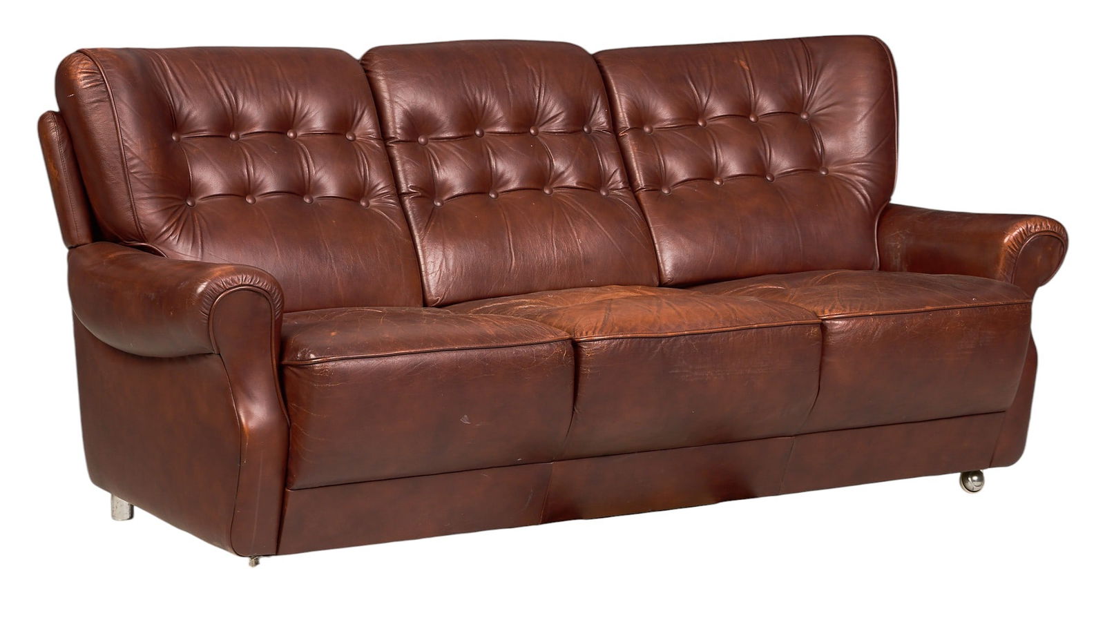 Danish Mid-Century Leather Sofa: Danish mid-century sofa of tufted, distressed reddish brown leather, supported on wheels and steel bar legsheight 34 in. x width 72 in. x width 31 in. 