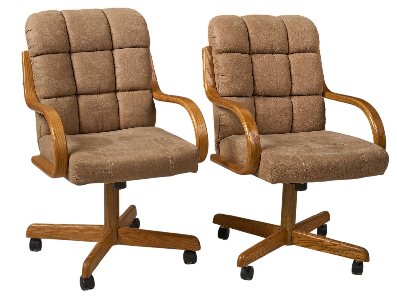Pair of Mid-Century Office Chairs: Pair of mid-century office chairs with tan fabric upholstery in a square-tufted design, featuring wooden armrests and raised on castersheight 31 in. x width 23 in. x depth 30 in. / eachProvenance: