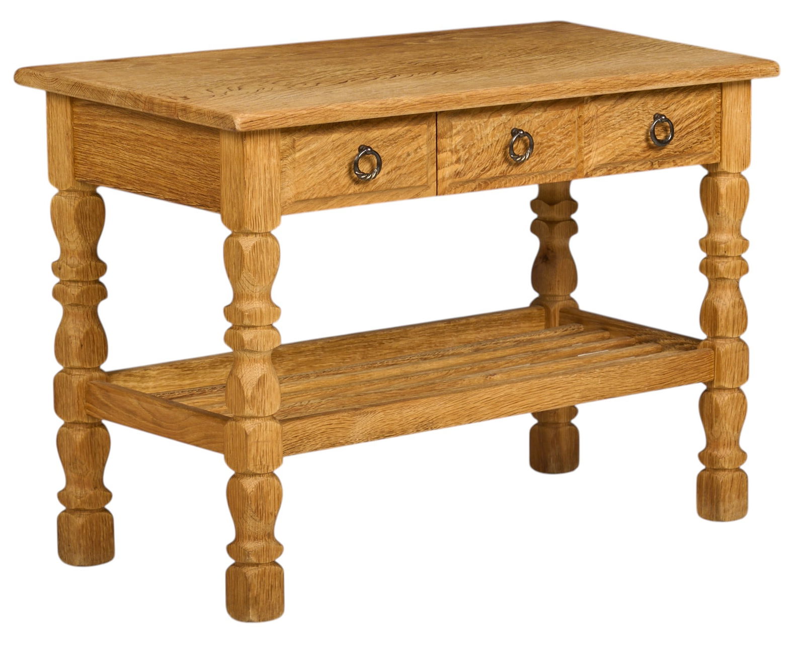 Henning Kjaernulf, Mid-Century Side Table: Henning Kjaernulf (Denmark) mid-century oak side table with three drawers, and lower rack, supported on sculpted block legs height 22 in. x width 29.5 in. x depth 16 in. 