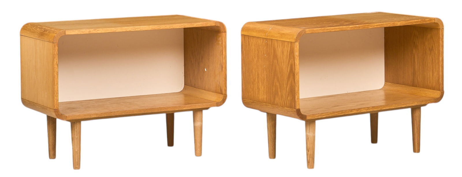 Pair of Danish Mid-Century Side Tables: Pair of Danish mid-century side tables with open storage and rounded edge design, supported on pin legsheight 23 in.x width 31.5 in. x depth 15.5 in. Condition: small area (3.5 x 1 in.) with