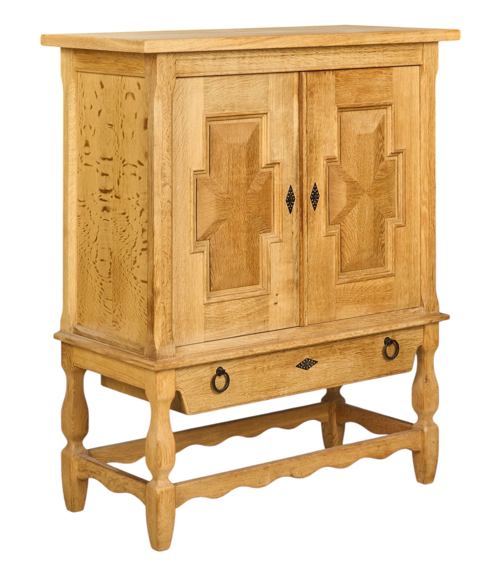 Henning Kjaernulf, Mid-Century Cabinet: Henning Kjaernulf (Denmark) mid-century oak cabinet with decoratively paneled cabinet doors, interior shelves, and lower drawer with iron pulls, supported on sculpted legs, with key height