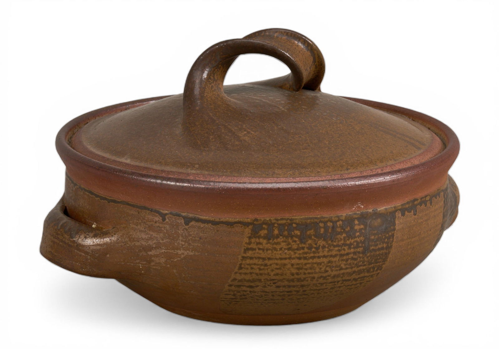 Karen Karnes Stoneware Lidded Casserole Dish: Karen Karnes stoneware lidded casserole dish, with brown glaze, turned handle on the lid, and side handles on the base, markedheight 9 in. x width 13 in. x depth 12 in.Provenance: Property