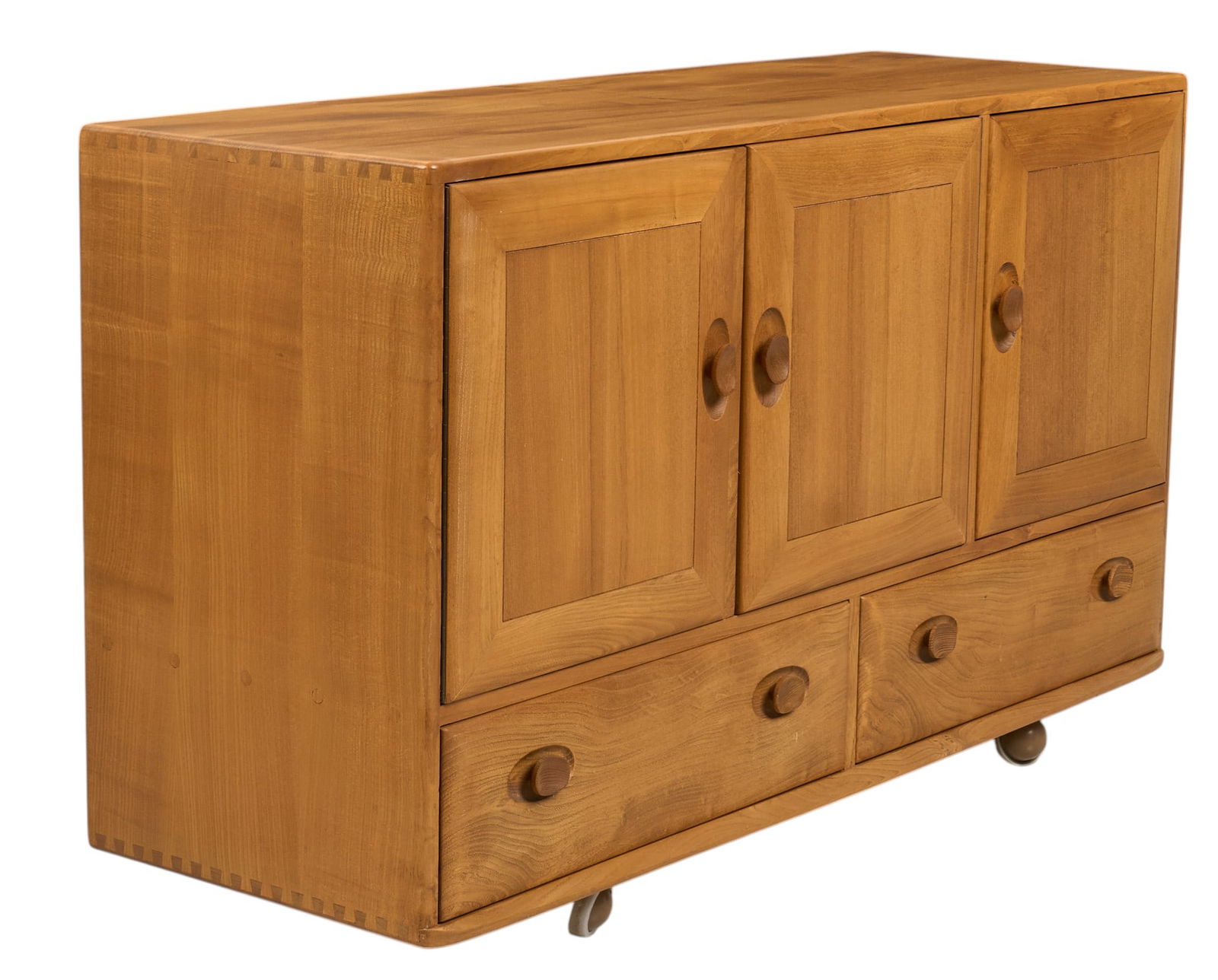 Ercol English Mid-Century Credenza: Ercol (England) mid-century elm wood credenza with pair of drawers, three of cabinet doors, and interior shelf and cutlery tray, supported on wheels, marked with Ercol sticker, circa