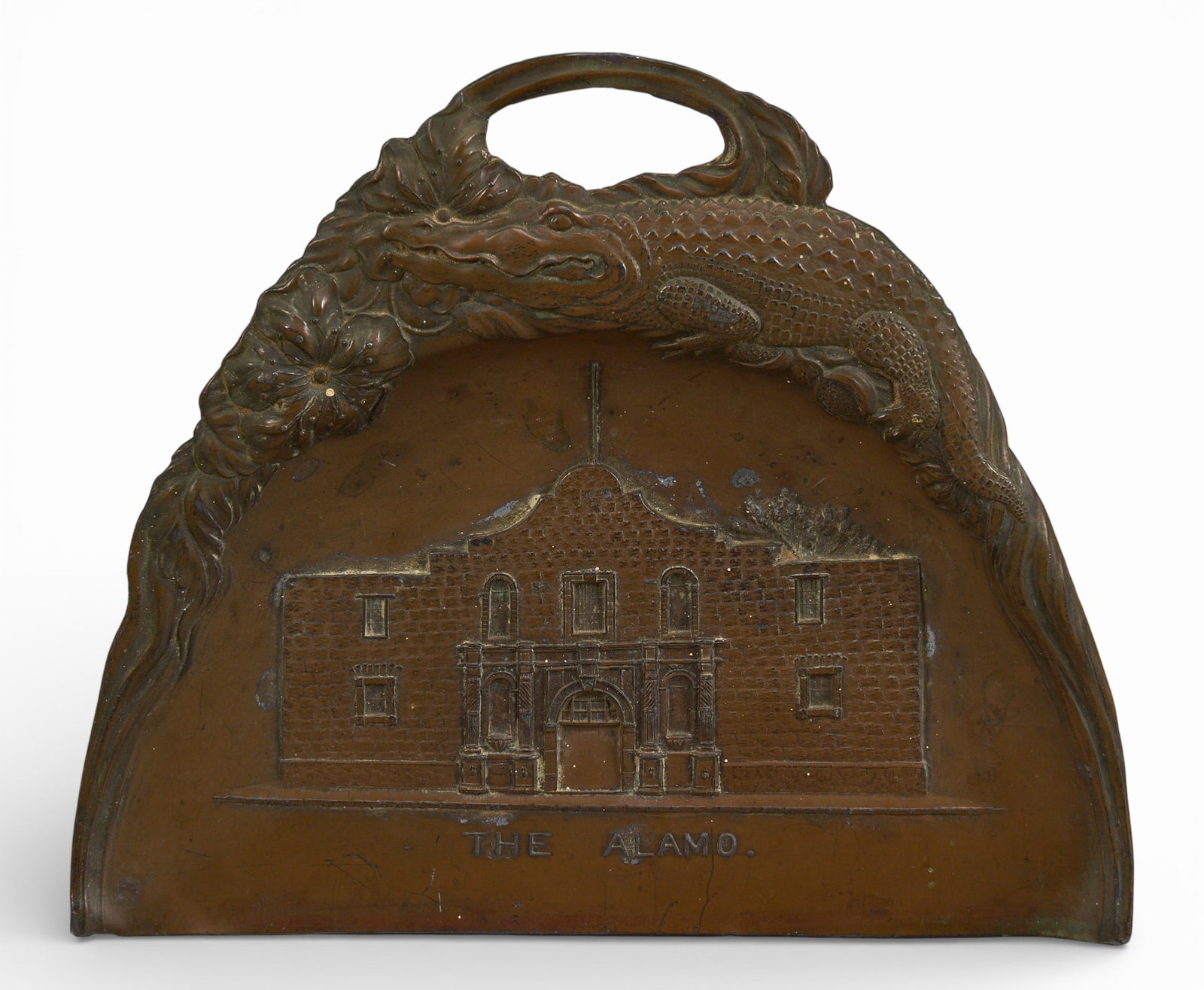 The Alamo Crumber: Cast bronze crumber with the Alamo in reservoir, alligator and floral motifs at framing border, likely a stock souvenir piece reproduced with various local landmarks, circa late 19th to early 20t