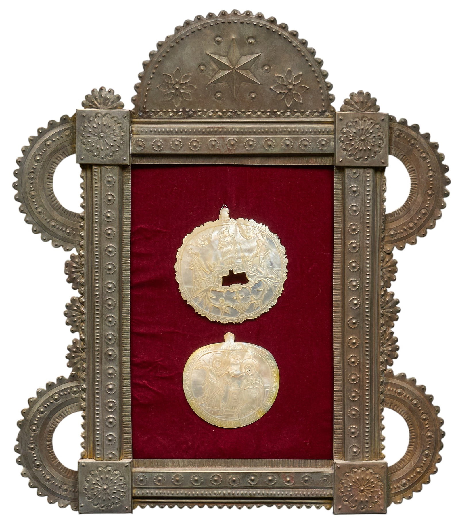 Carved Abalone Medallions in Nicho Frame: Two carved abalone medallions with hand-tooled religous imagery, mounted in pressed tin nicho frame height 24 in. x width 21 in. x depth 1 in. Provenance: The Estate collection of late teacher a