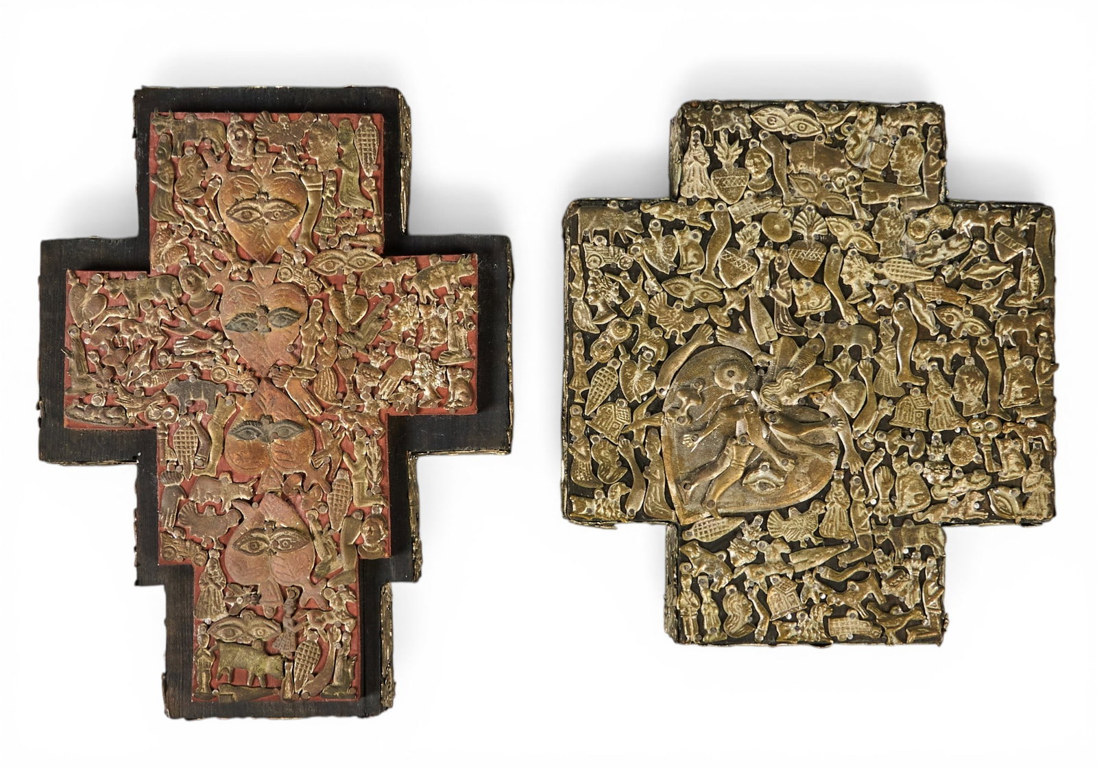 (2) Milagro Crosses: Two antique wooden crosses embedded with numerous milagro charms, circa 19th century height 10 in. x width 8 in. x depth 2 in. / largest Provenance: The Estate collection of late teacher and hum