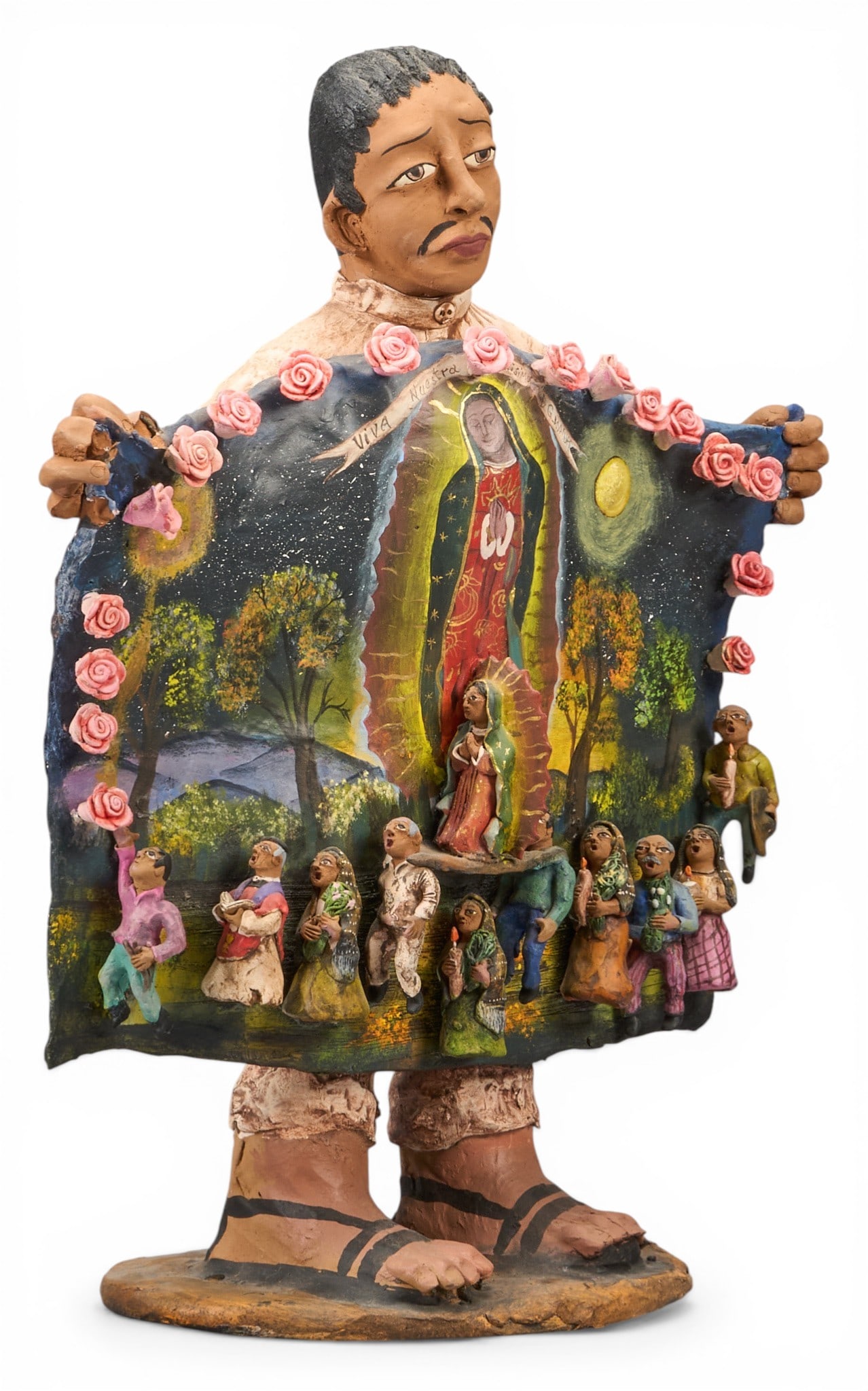 Lorenzo Aguilar, Figural Religious Sculpture: Lorenzo Demetrio Garcia Aguilar (Ocotlan de Morelos, Oaxaca, Mexico, 20th c.) hand-modeled and painted ceramic sculpture depicting figure holding tapestry of La Virgen da Guadalupe over religious proc
