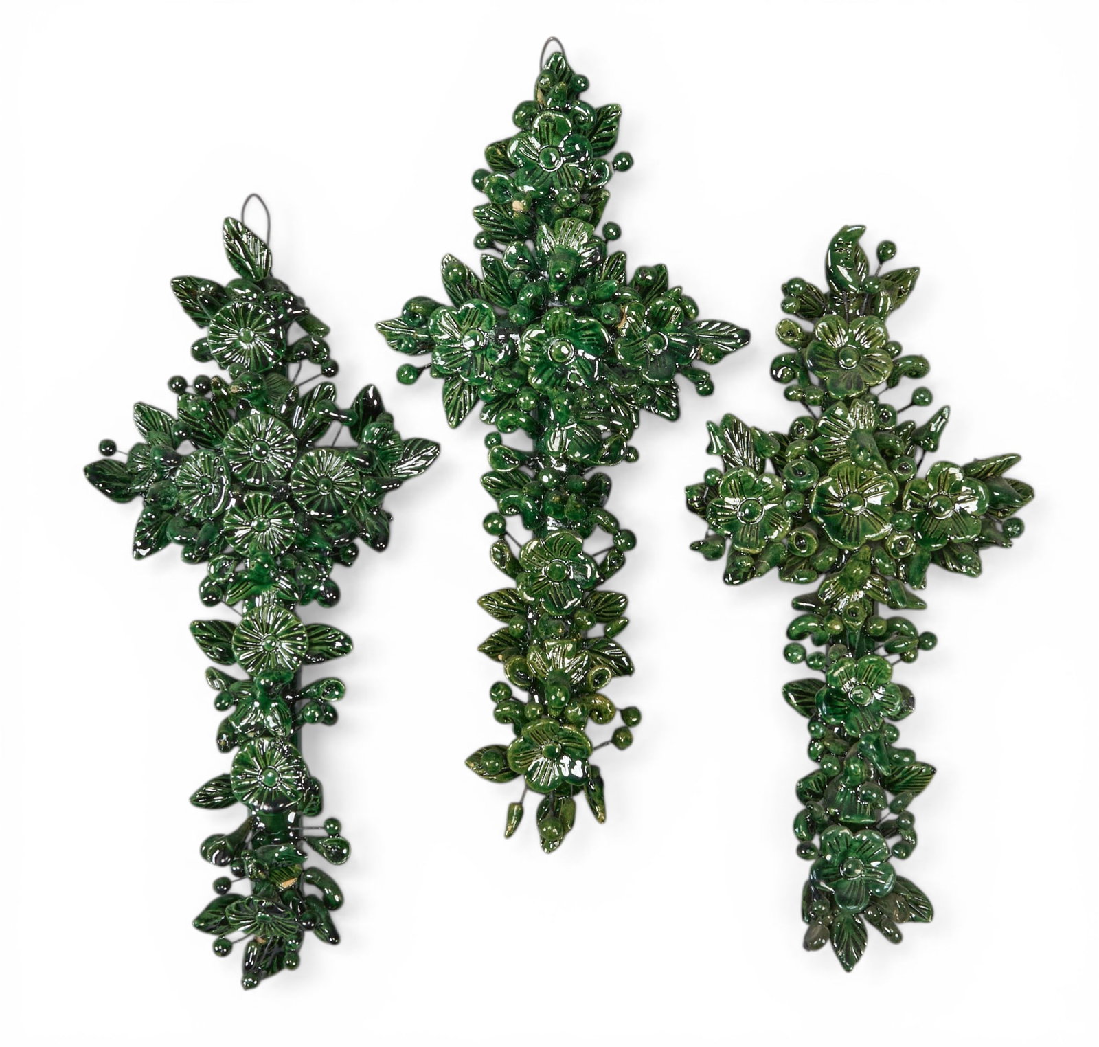 (3) Michoacan Crosses: Set of three vintage hand-made and glazed Michoacan ceramic crosses with botanical crosses, wired for hanging, circa 20th century height 12 in. x width 6 in. x depth 2 in. / each Provenance: The