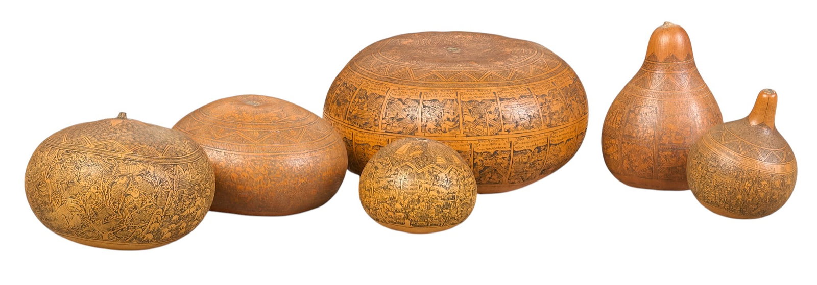 (6) Peruvian Gourds: Collection of six hand-tooled Peruvian folk art gourds, each with intricately carved scenes with various motifs height 4 in. x width 8 in. x depth 9 in. / largestProvenance: The Estate