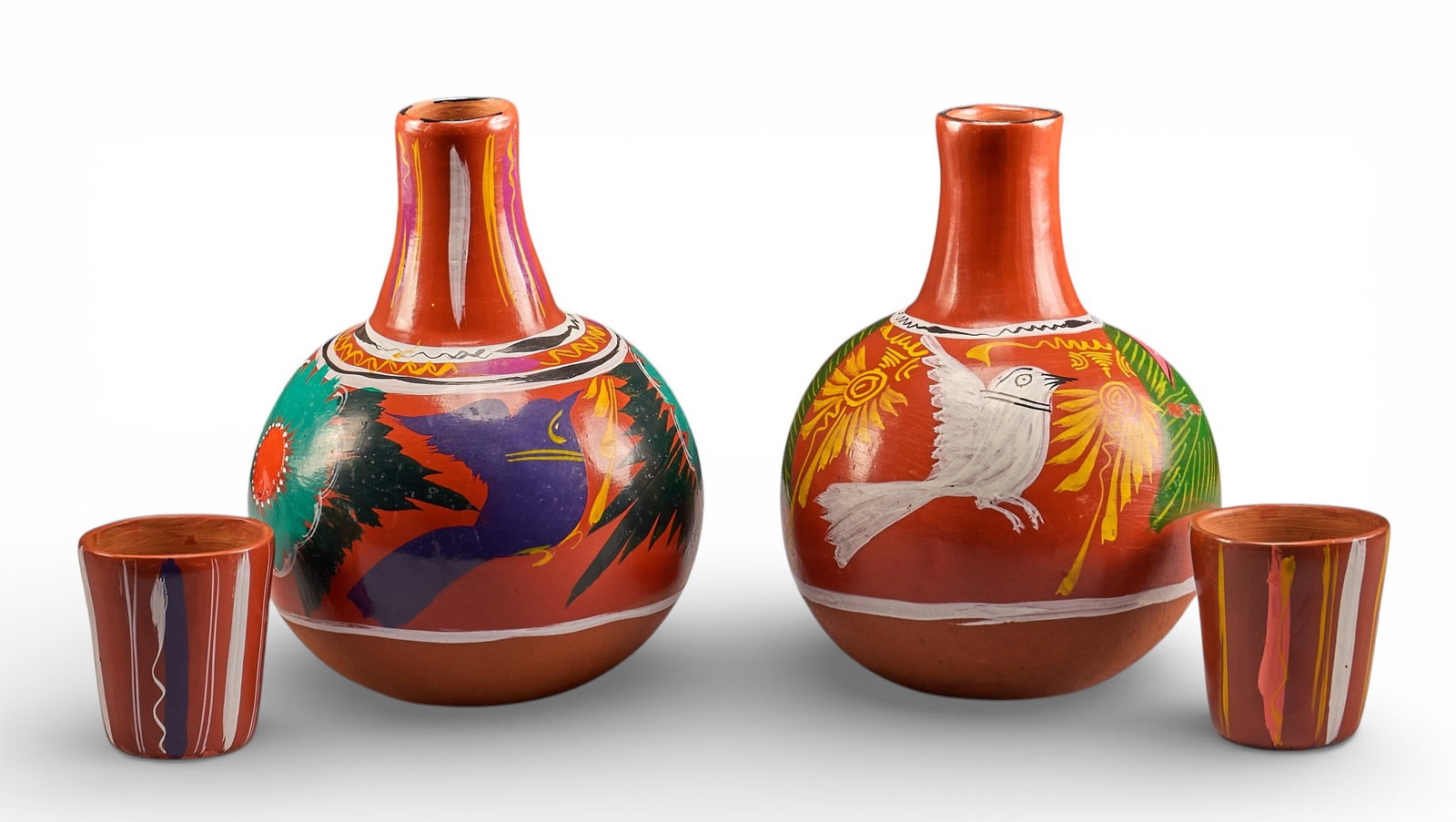 Pair of Mexican Water Vases with Cups: Pair of vintage hand-made and painted Mexican ceramic water jugs with cup, circa early 20th centuryheight 13 in. x width 9 in. x depth 9 in. / eachProvenance: Property from a home in Goldwaithe, Texas