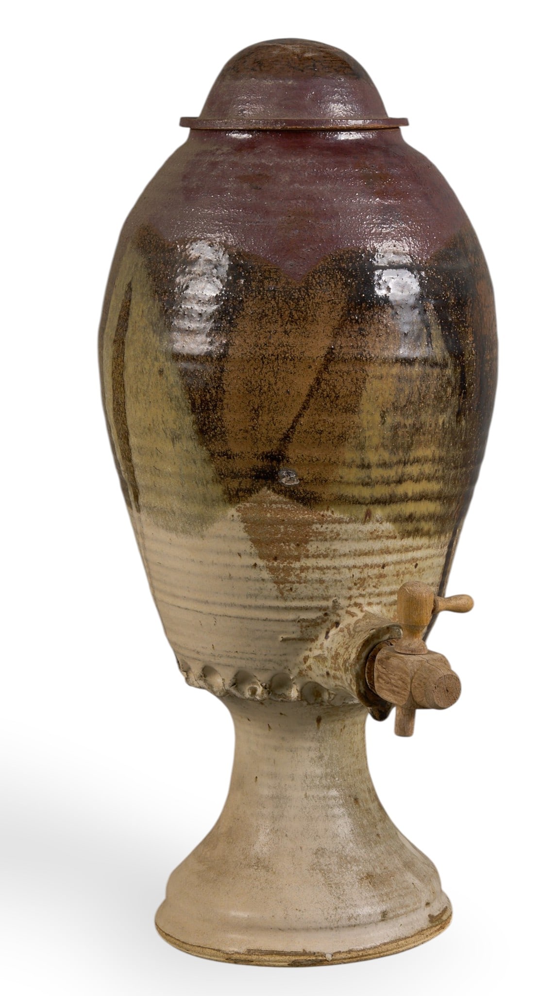 Mexican Pottery Water Dispenser: Handmade Mexican ceramic water dispenser with lid and spigot, bulbous body, pedestal base height 24 in. x width 10 in. x depth 10 in. Provenance: Property from a home in San Antonio, Texas