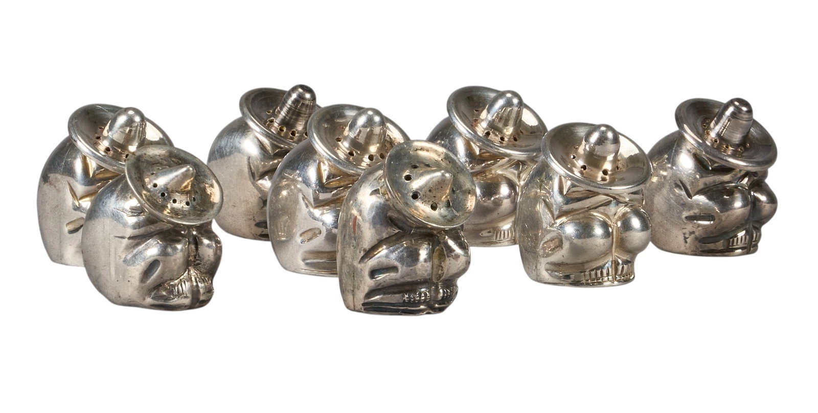 (8) Mexican Sterling Salt and Pepper Shakers: Set of eight Mexican sterling silver salt and pepper shakers, depicting figures in kneeing or crouched position, marked "925 Made in Mexico" to undersides height 1.75 in. x width 1.25 in. x