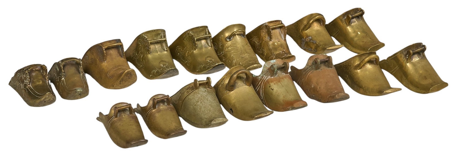 (17) Brass Conquistador Stirrups: Collection of seventeen vintage brass conquistador stirrups height 5 in. x width 4.5 in. x depth 12 in. / largest Provenance: Property from a historic home in the Olmos Park neighborhood of San Antoni