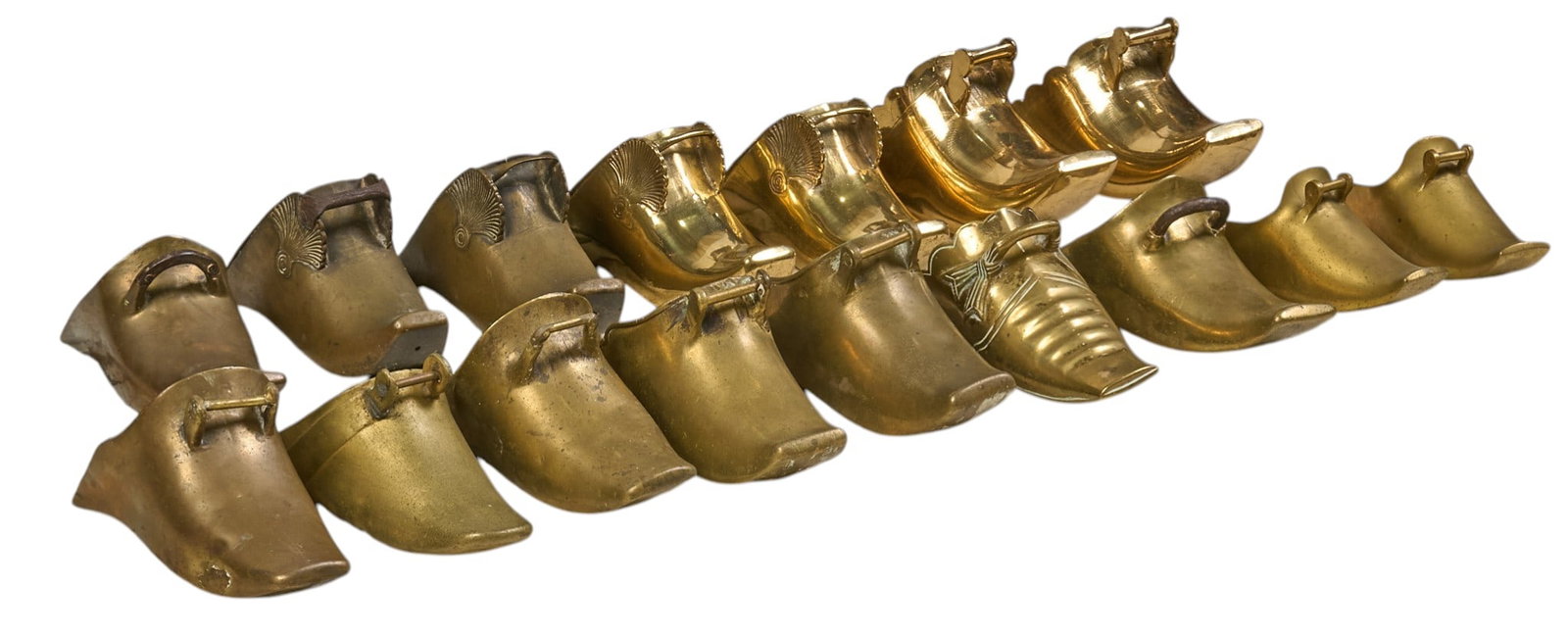 (16) Brass Conquistador Stirrups: Collection of sixteen vintage brass conquistador stirrups height 6 in. x width 5 in. x depth 11 in. / largest Provenance: Property from a historic home in the Olmos Park neighborhood of San Antonio, T