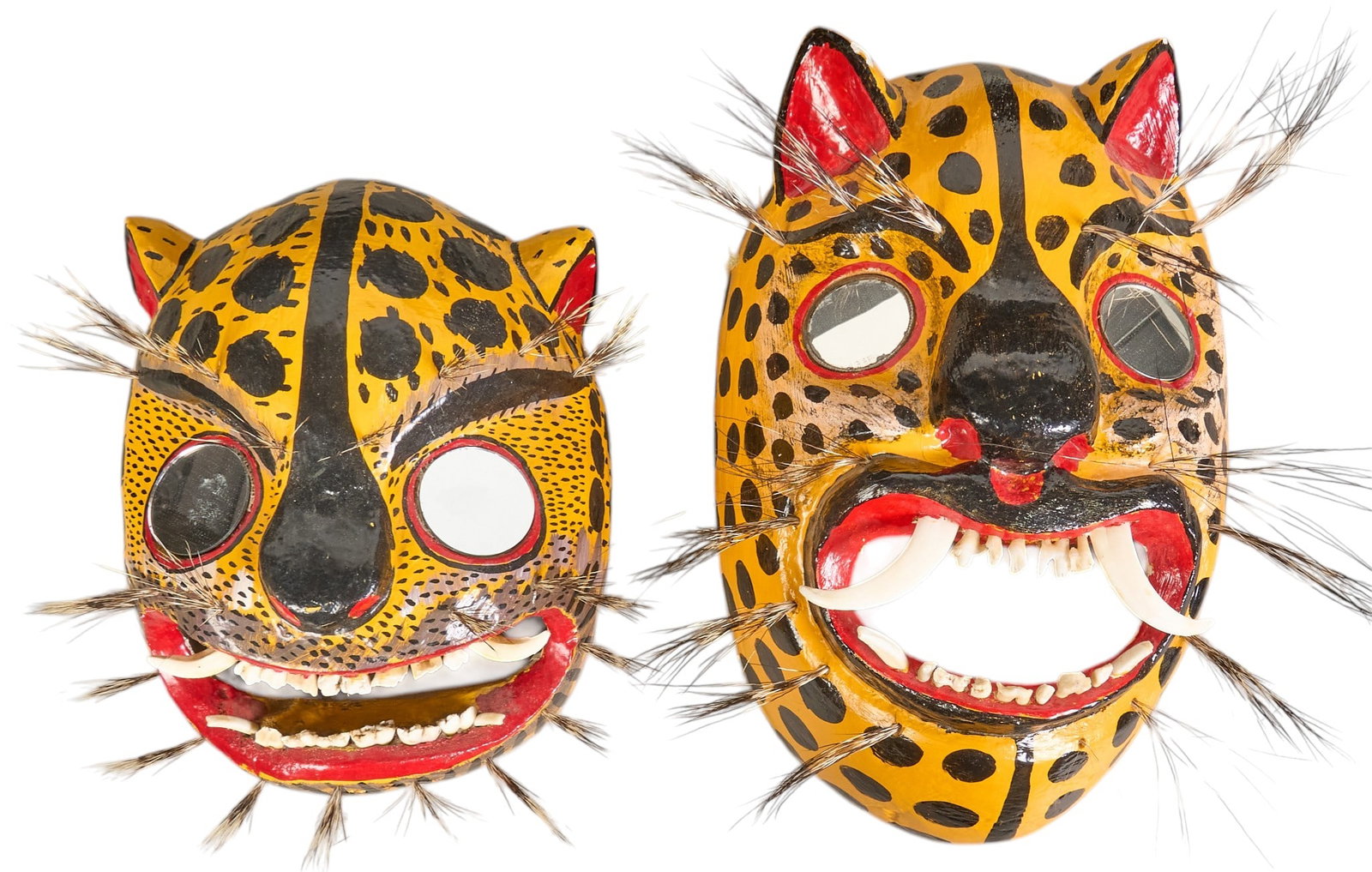 (2) Vintage Mexican Tigre Masks: Pair of vintage Mexican (Guerrero) folk art Danza de la Tigre (dance of the tiger/jaguar) masks, hand-painted and lacquered soft wood with mirrored eyes, boar hair bristles and teeth, circa