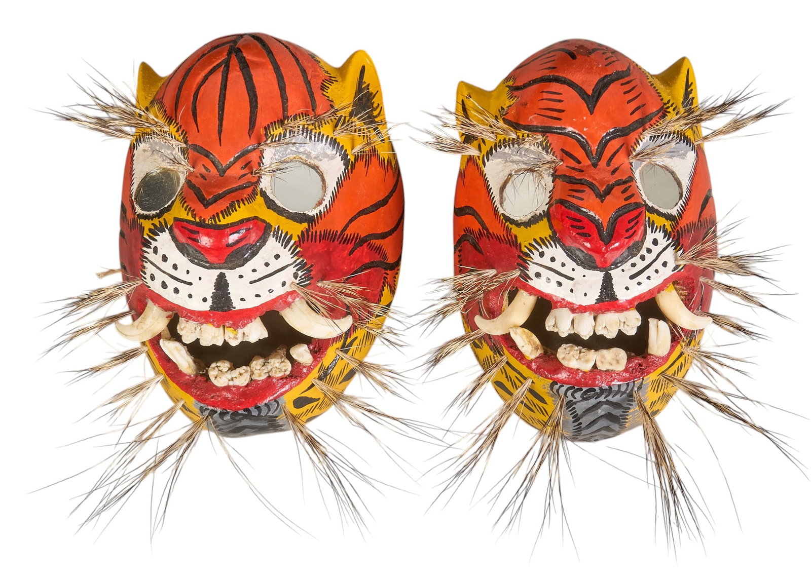 Pair of Vintage Mexican Tigre Masks: Pair of vintage Mexican (Guerrero) folk art Danza de la Tigre (dance of the tiger/jaguar) masks, hand-painted and lacquered soft wood with mirrored eyes, boar hair bristles and teeth, circa