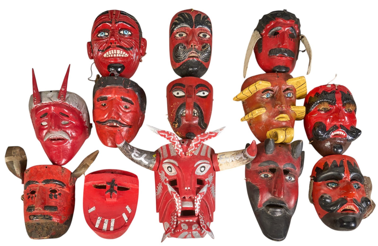 (13) Folk Art Dance Masks: Collection of thirteen hand-made and painted folk art dance masks, with multiple styles, and varying ages height 12 in. x width 16 in. x depth 8 in. / largest Provenance: The Estate collect