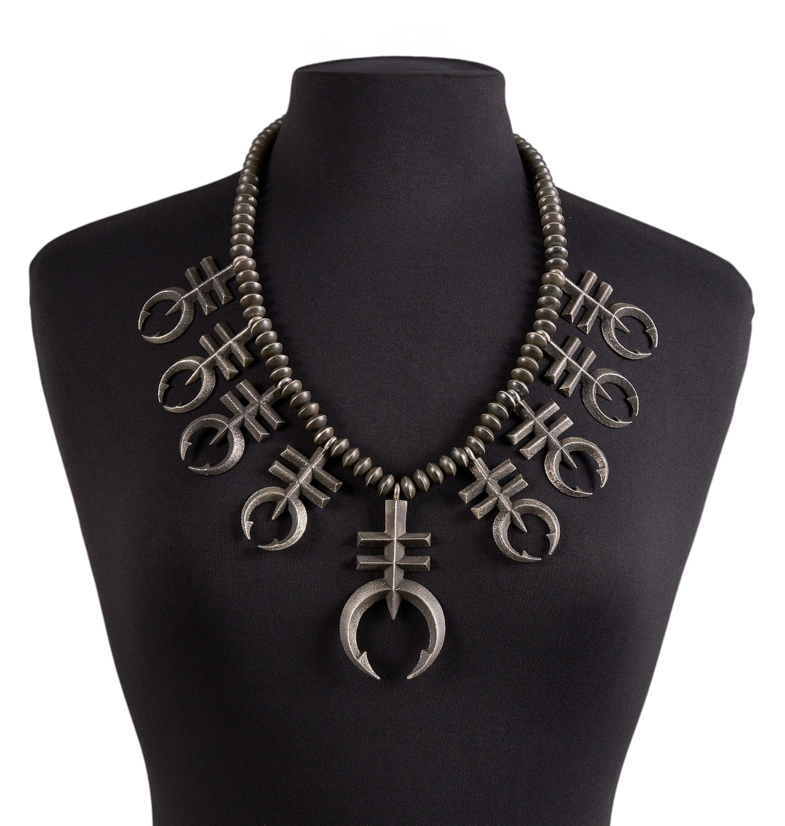 Navajo Sandcast Sterling Double Cross Necklace: Navajo sandcast sterling silver necklace, set with double-barred crosses, and hook and eye closure Length: 27 in. Total weight: 10.69 ozt Provenance: Property from the personal archive of a 