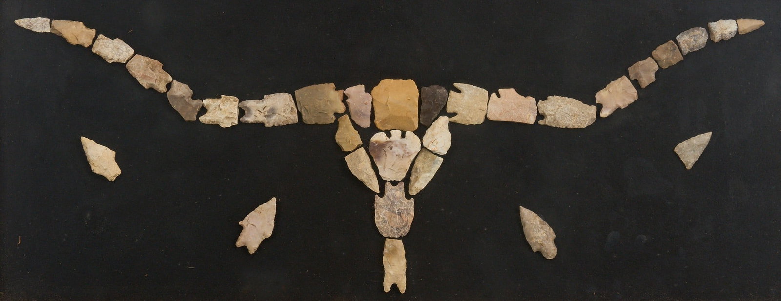 Framed Texas Longhorn Arrowhead Display: Framed collection of stone projectile points arranged in shape of longhorn head height 19 in. x width 38.5 in. x depth 1.5 in. Provenance: Property from a home in San Antonio, Texas 