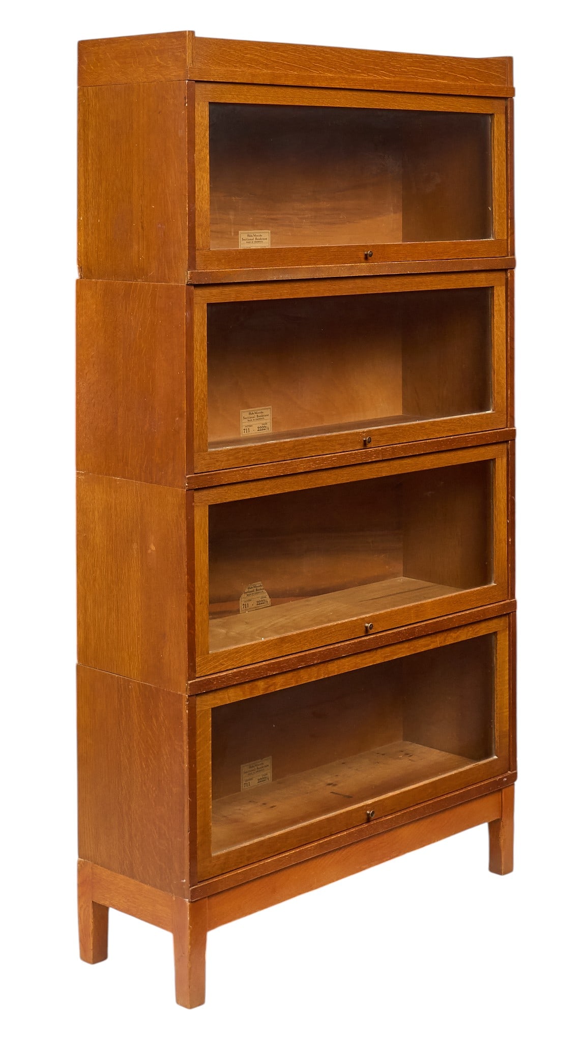Globe-Wernicke Stacking Bookcase: Globe-Wernicke stacking barrister bookcase with four glass-front tiers, supported on base with block legs, marked pattern 711 height 63 in. x width 34 in. x depth 11.5 in. Provenance: Property from a 