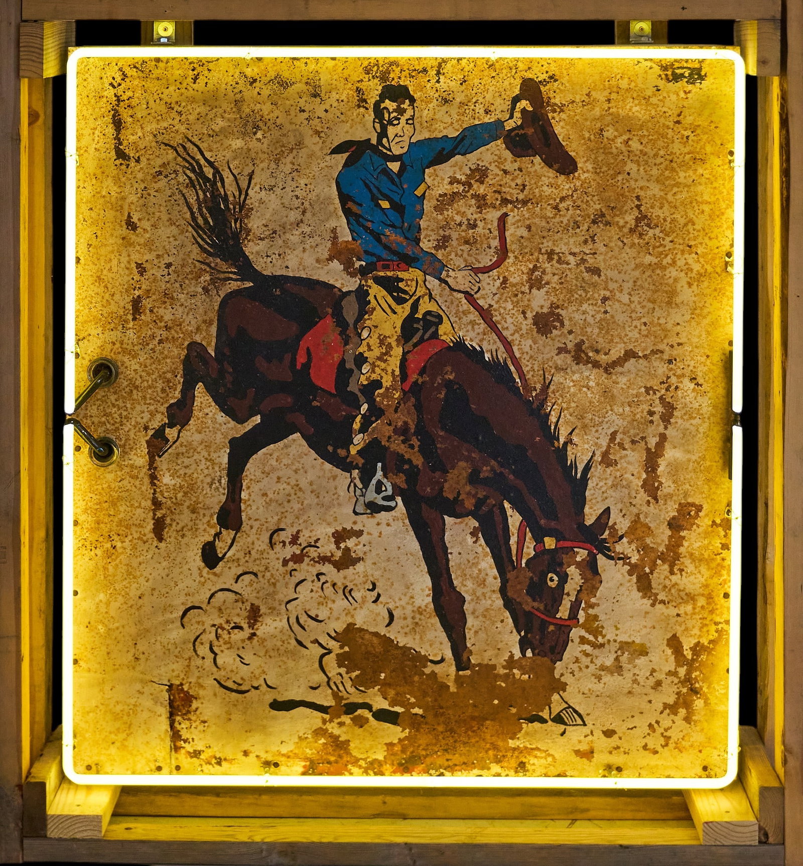 Bucking Bronco Neon (Right Facing): Custom-made Western style neon sign with rustic painted metal sign depicting cowboy on bucking bronco facing right with newer neon tubing height 47 in. x width 46 in. x depth 9 in. Provenance: