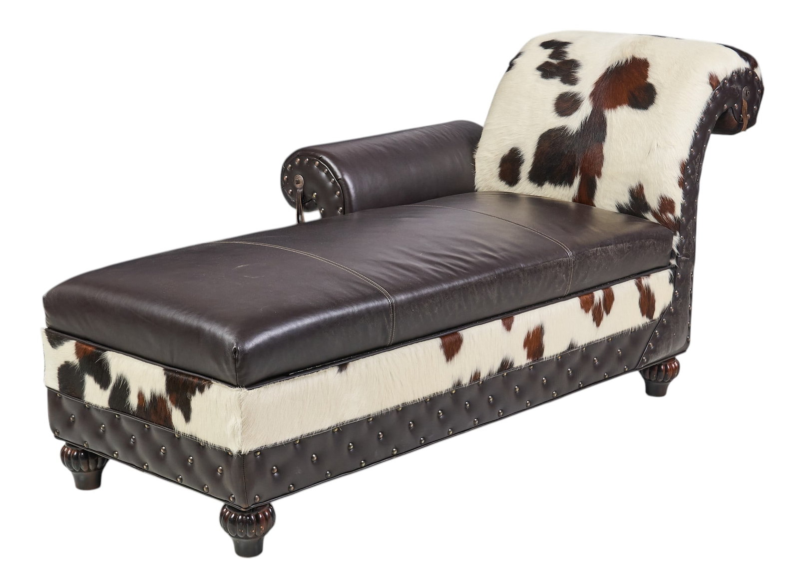 Ranch Style Chaise: Ranch style chaise lounge with leather and hair on cowhide upholstery, and storage seat with gun racks, supported on turned legs height 38 in. x width 65 in. x depth 37 in. Provenance: Property