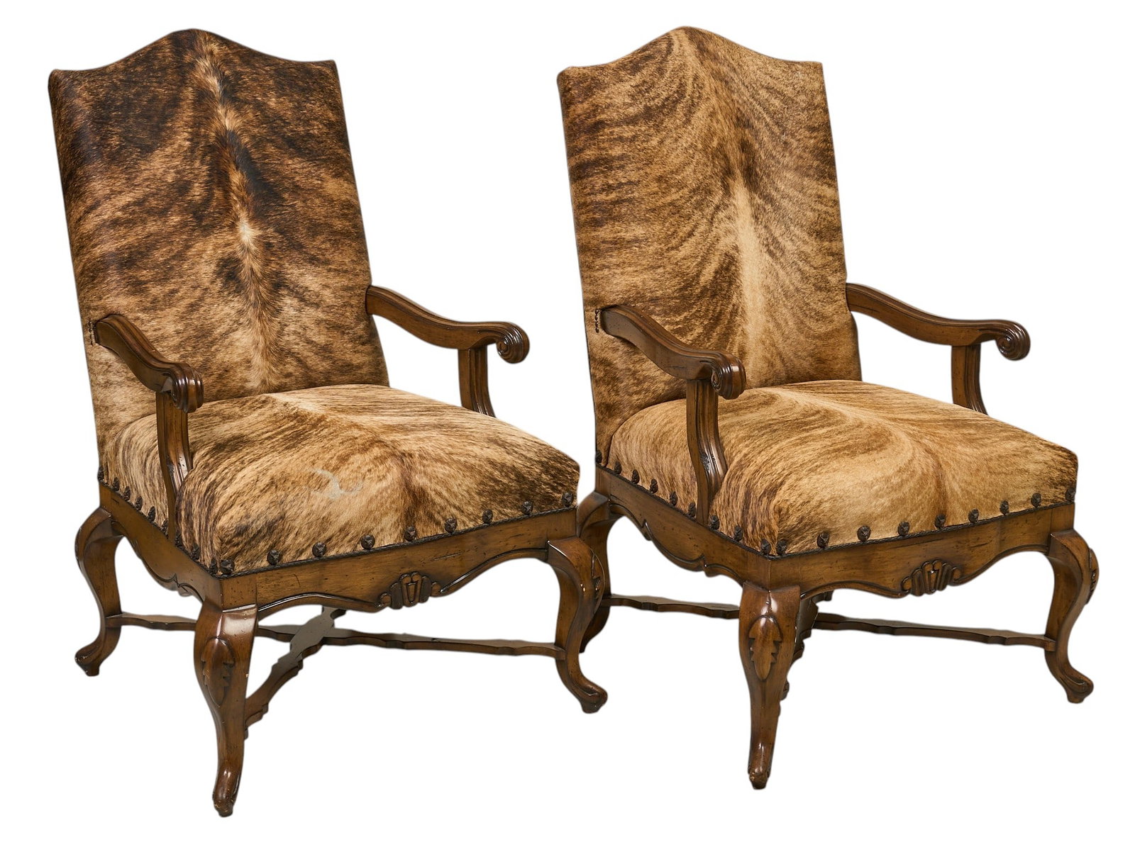 Pair of Hair on Hide Armchairs: Pair of ranch style armchairs with carved frames, and hair on hide upholstery height 47 in. x width31 in. x depth 34 in. / each Provenance: Property from the Estate of Robert A. "Bob" Funk