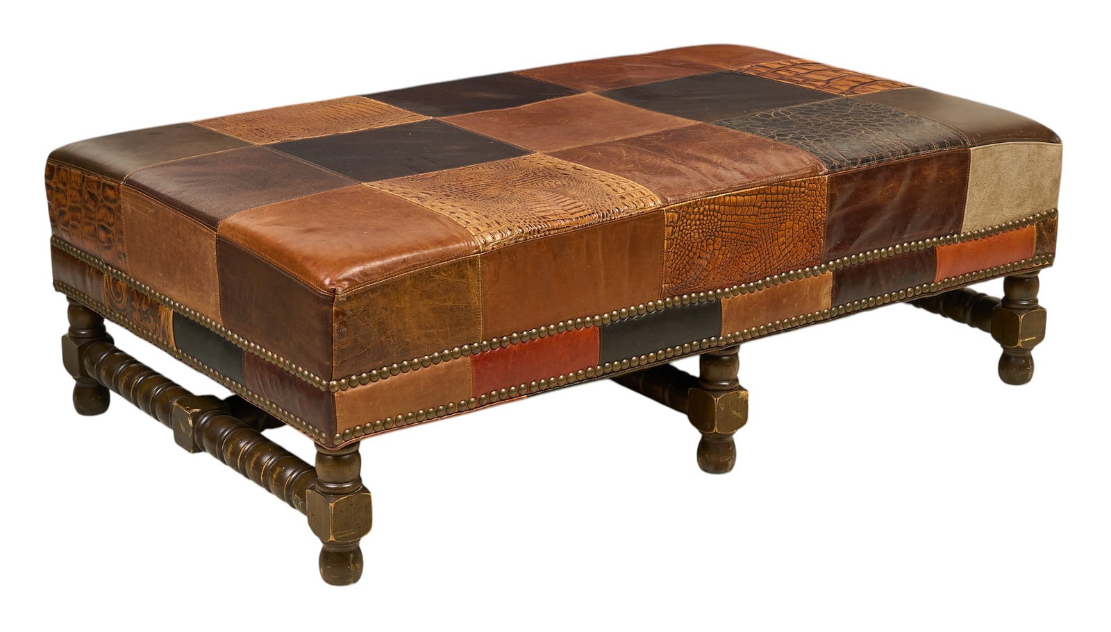 Paul Roberts, Leather Ottoman: Paul Roberts leather patchwork mosaic ottoman supported on turned legs height 18 in. x width 54.5 in. x depth 33 in. Provenance: Property from a home in San Antonio, Texas 