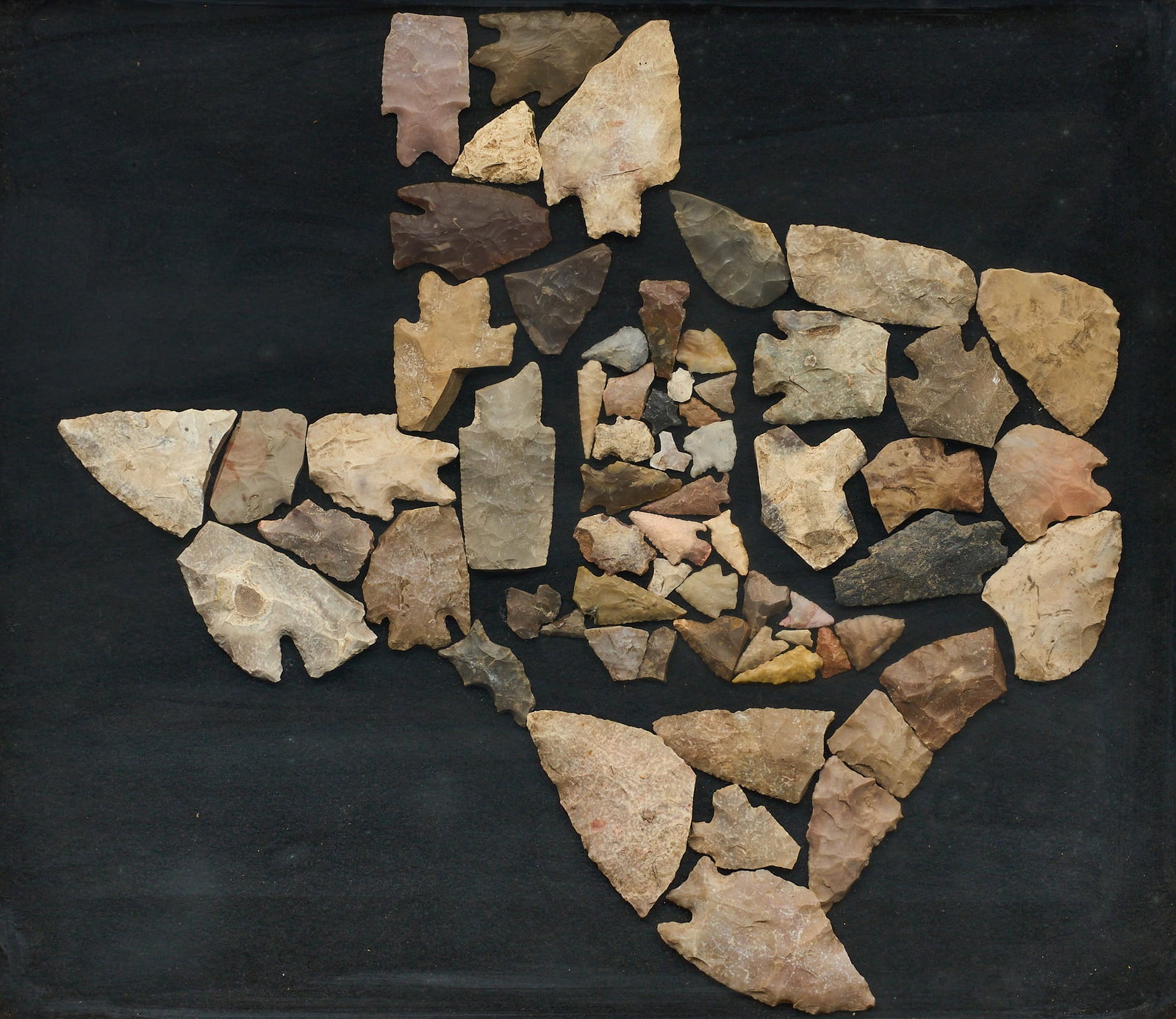 Framed Texas Arrowhead Display: Framed collection of hand-made stone projectile points arranged in shape of Texas sight: 16 x 18.5 in., frame: 22 x 24.5 in. Provenance: Property from a home in San Antonio, Texas