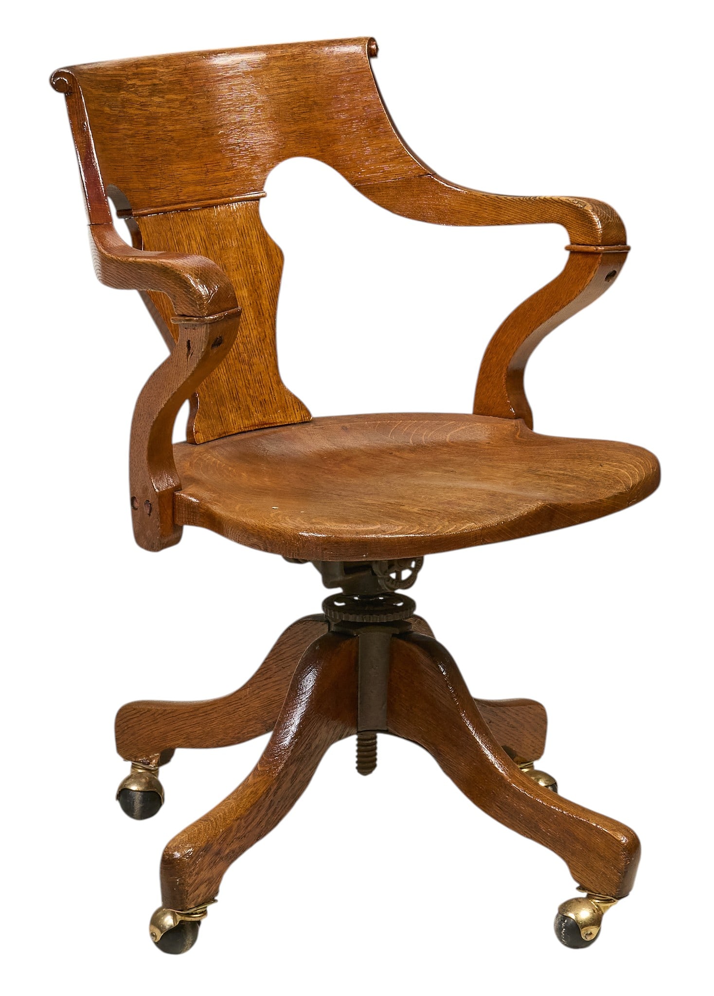 Antique Swivel Desk Chair: Antique wooden swivel desk chair with a curved backrest, sculpted seat, and four-legged base with casters height 35 in. x width 23.5 in. x depth 25 in. Provenance: Property fr