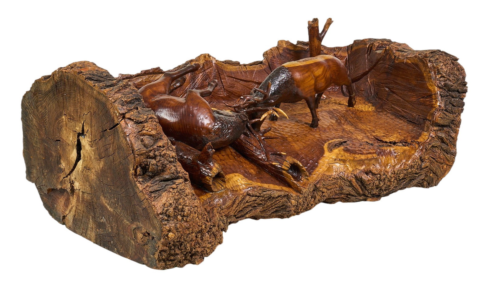 Live Edge Elk Sculpture: Large one-piece carving from a tree trunk depicting bull elks in antler lock, with plaque from 2007; freestanding height 21.5 in. x width 58 in. x depth 31 in. Condition: some loss to antler